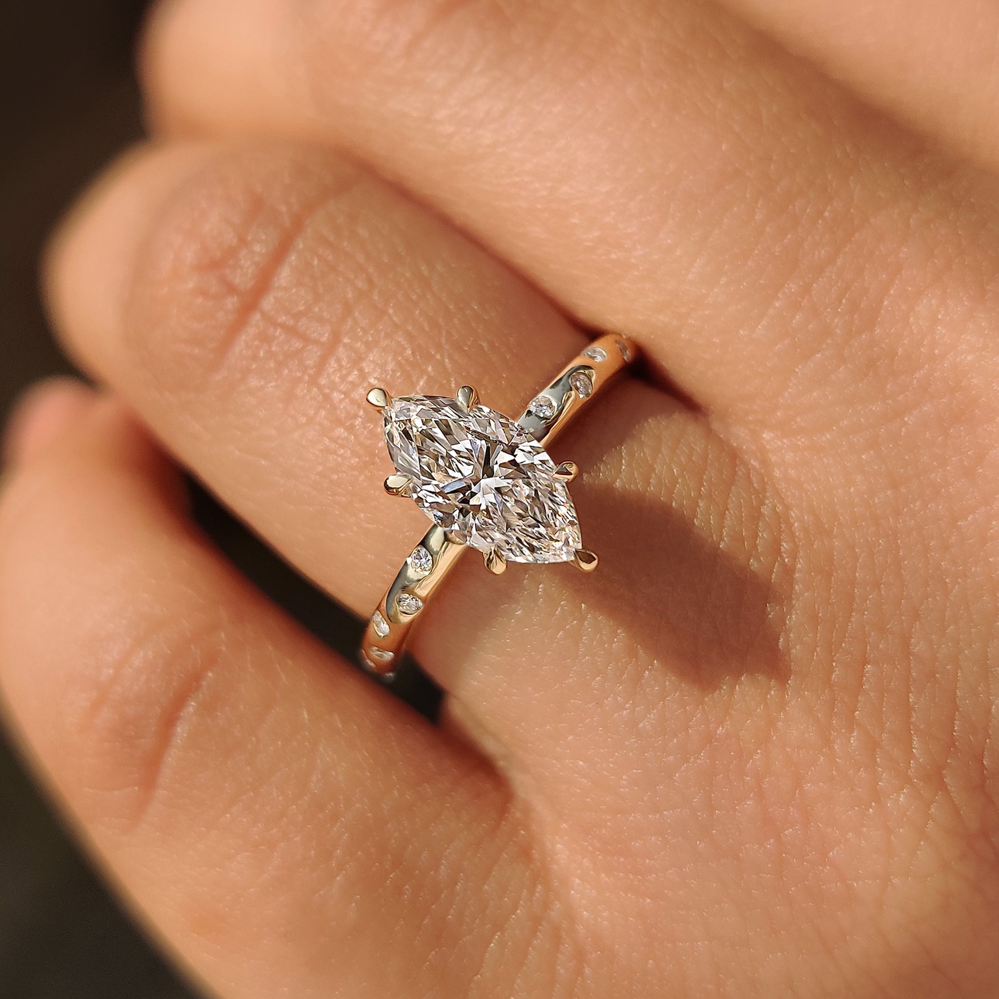 Custom diamond ring featuring marquise diamond and round cut side diamonds.
