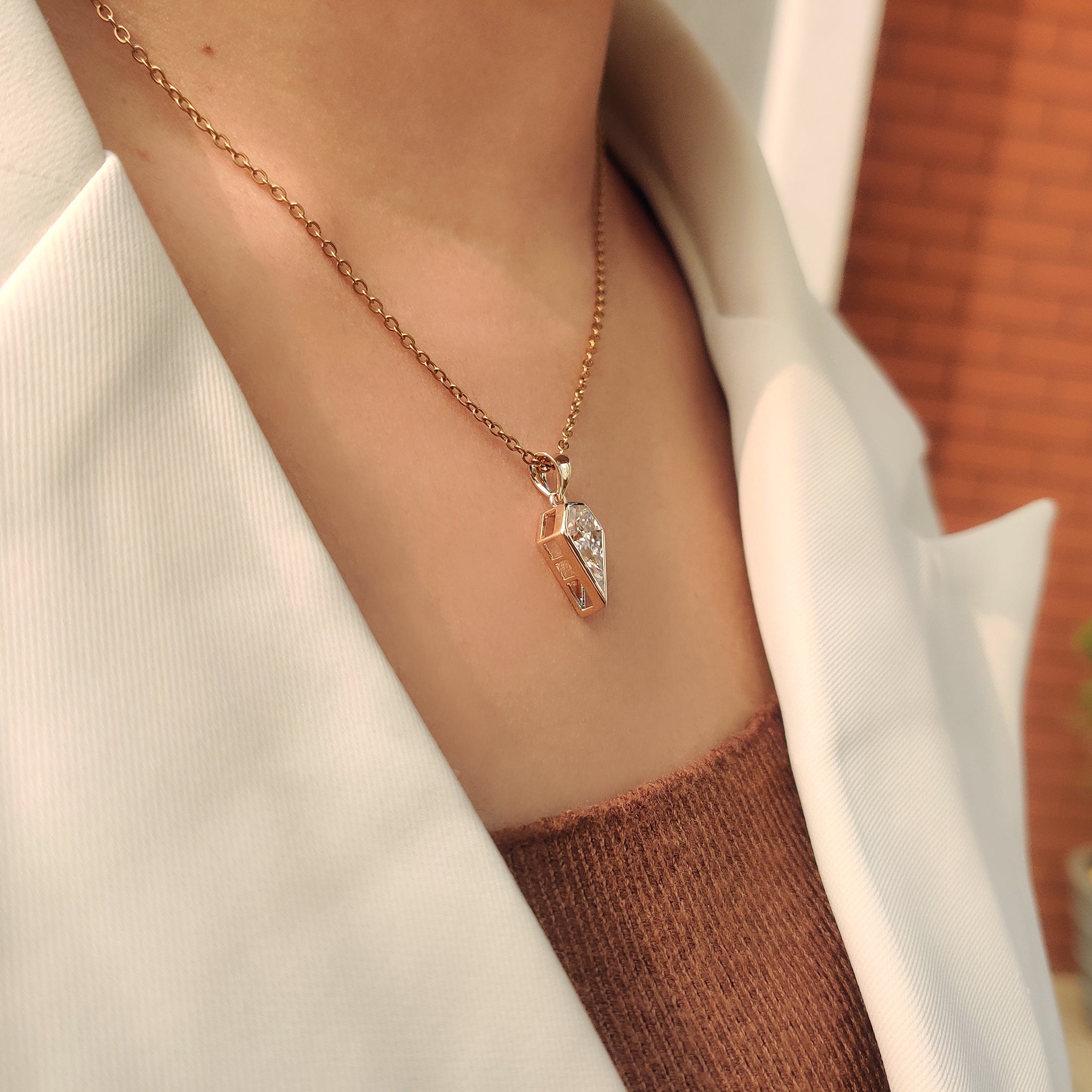 Moissanite solitaire pendant with spear cut design.

