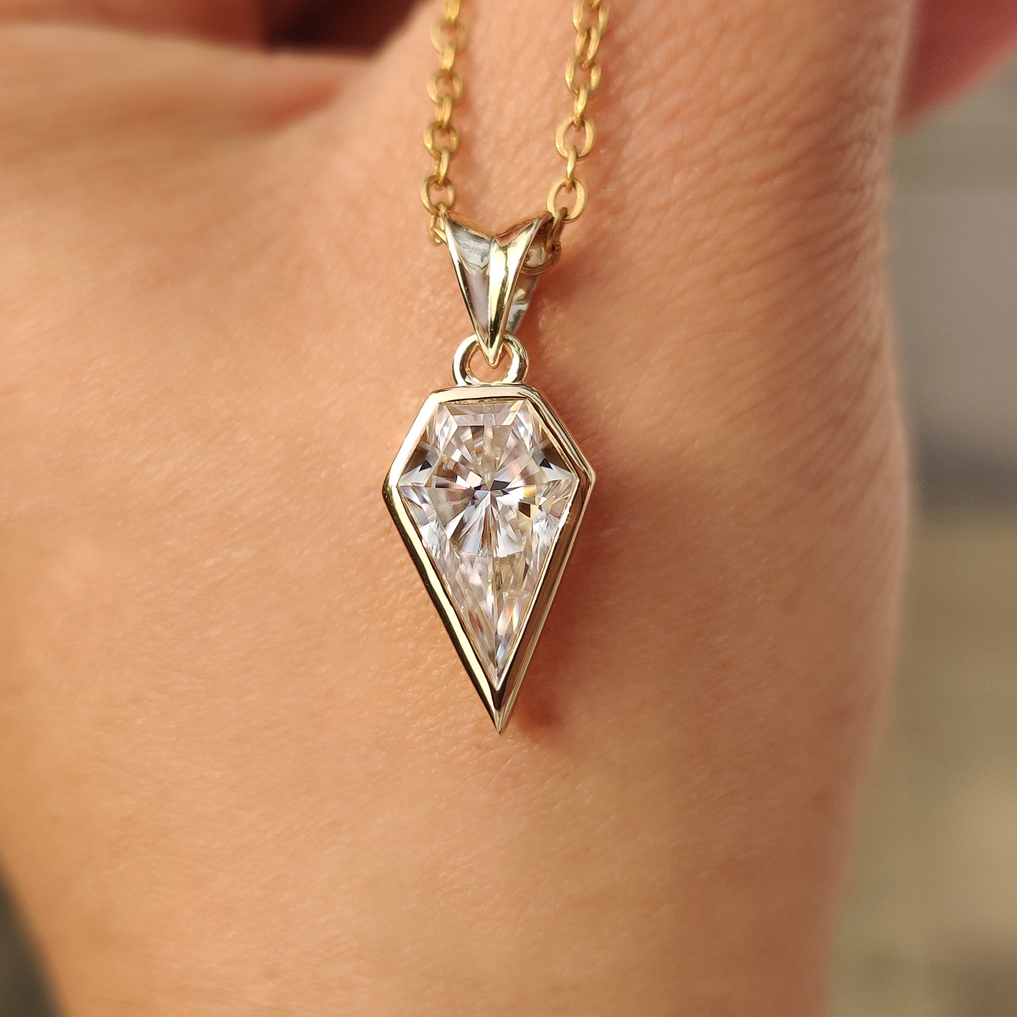 Bezel setting spear cut moissanite pendant design.
