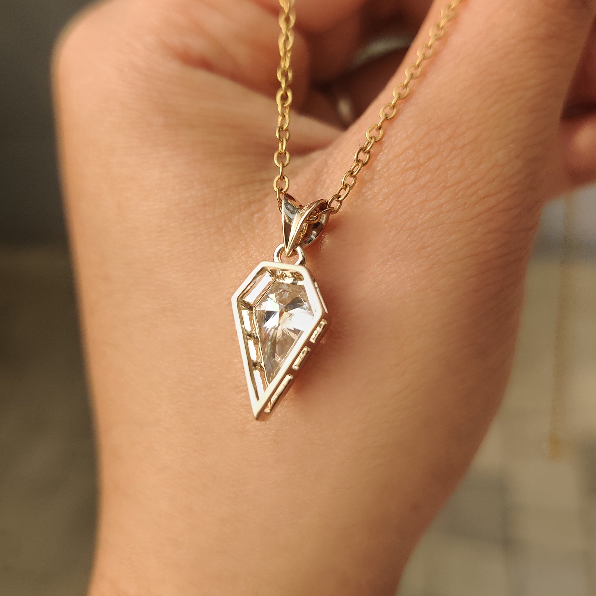 Moissanite solitaire pendant with sleek bezel design.
