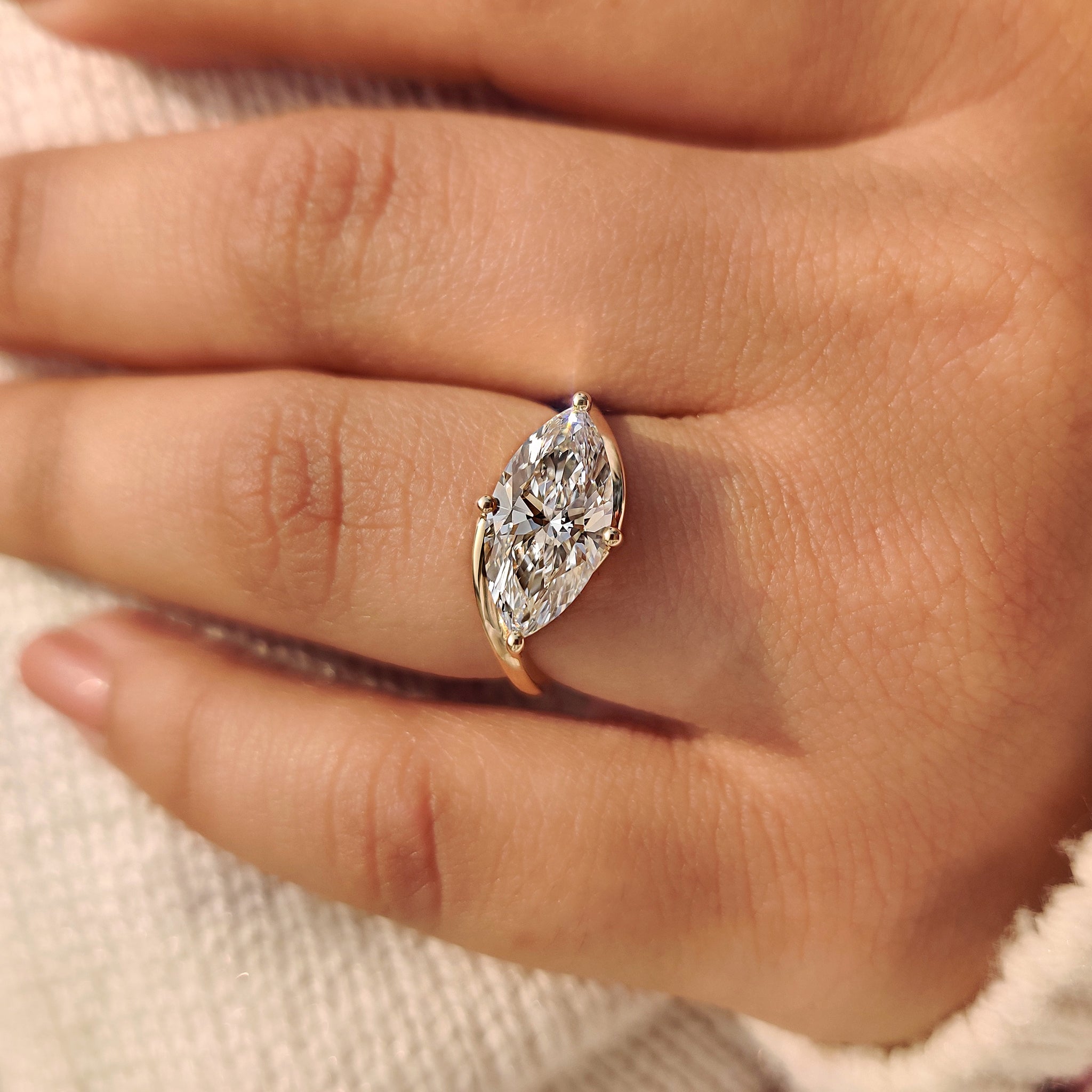 East to west setting on marquise diamond solitaire ring with bypass setting.
