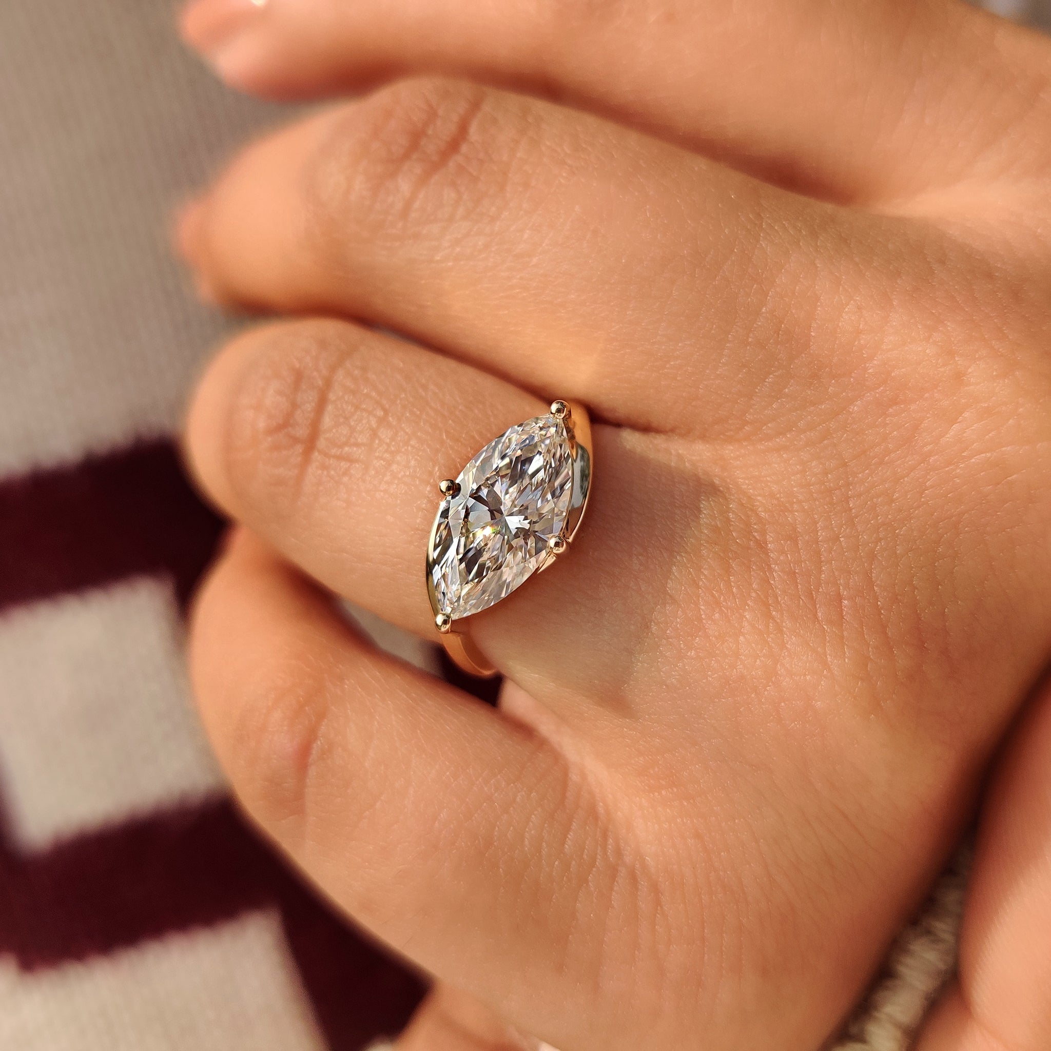 Carat Diamonds marquise diamond solitaire ring with east to west setting.
