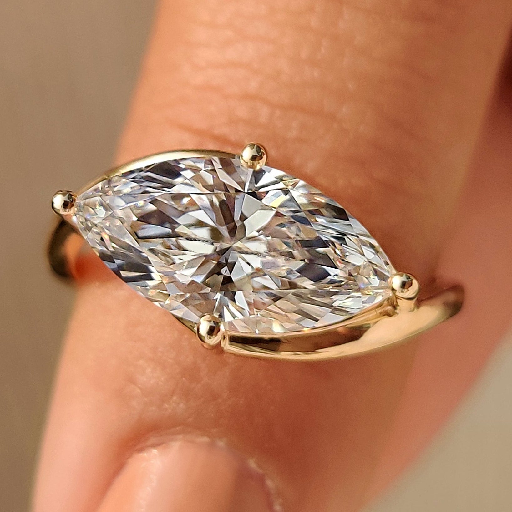 Marquise diamond solitaire ring with east to west setting and bypass setting.
