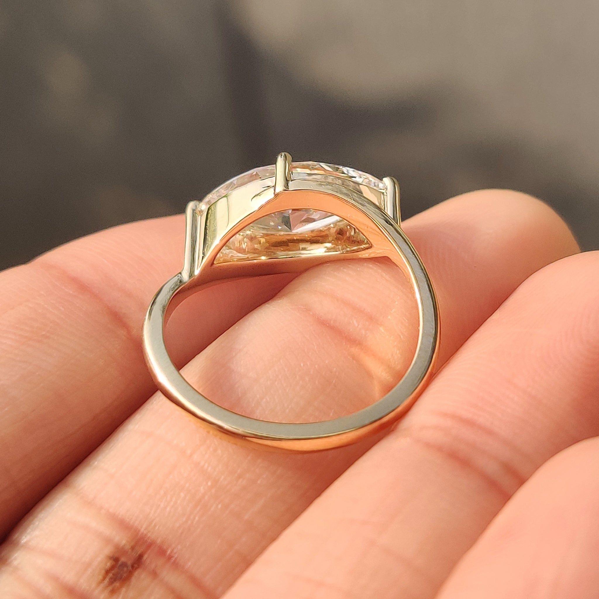 4 prong setting on marquise diamond solitaire ring with bypass setting.
