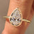 Pear cut diamond ring in solitaire style with bezel prongs.
