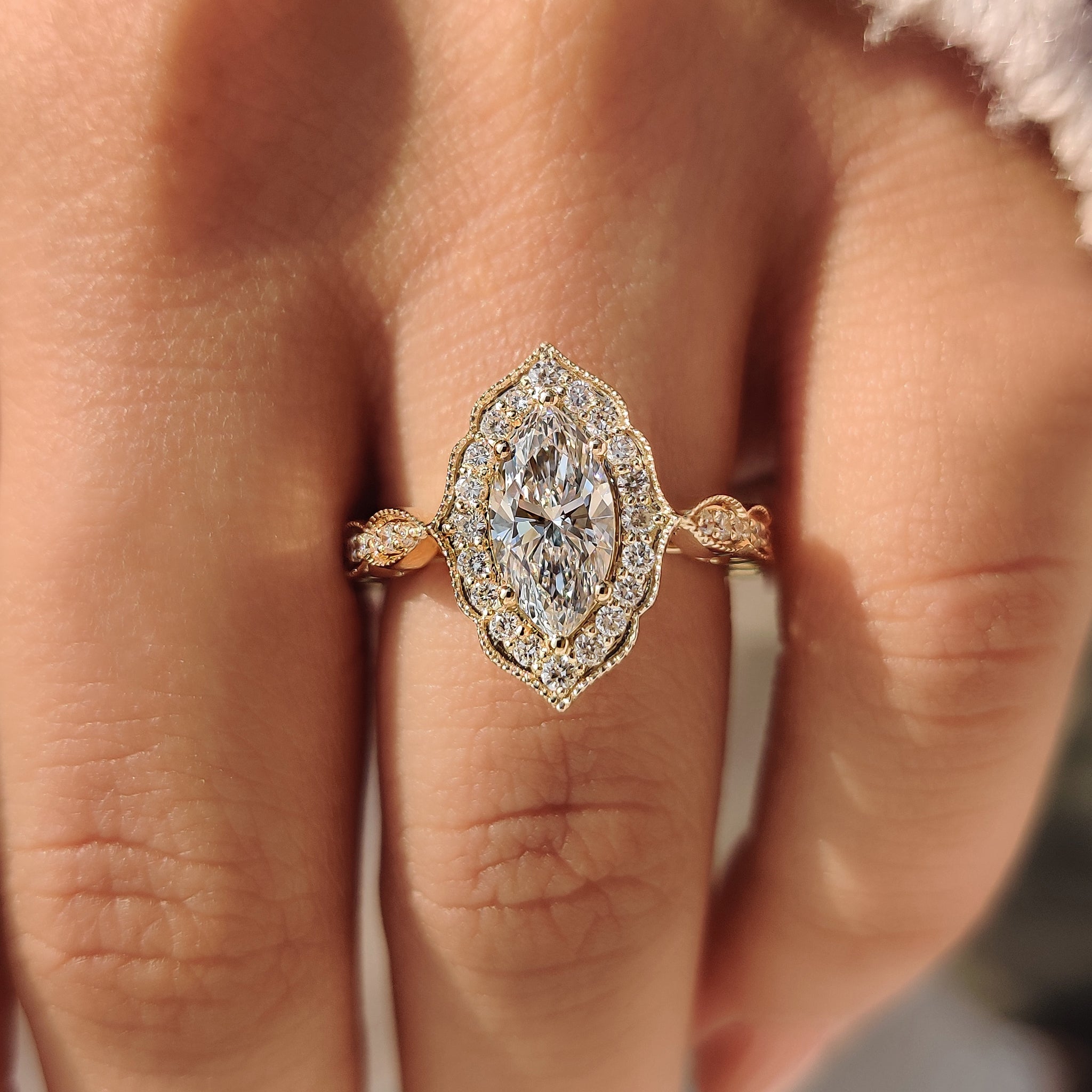 Vintage style marquise cut diamond ring with halo.
