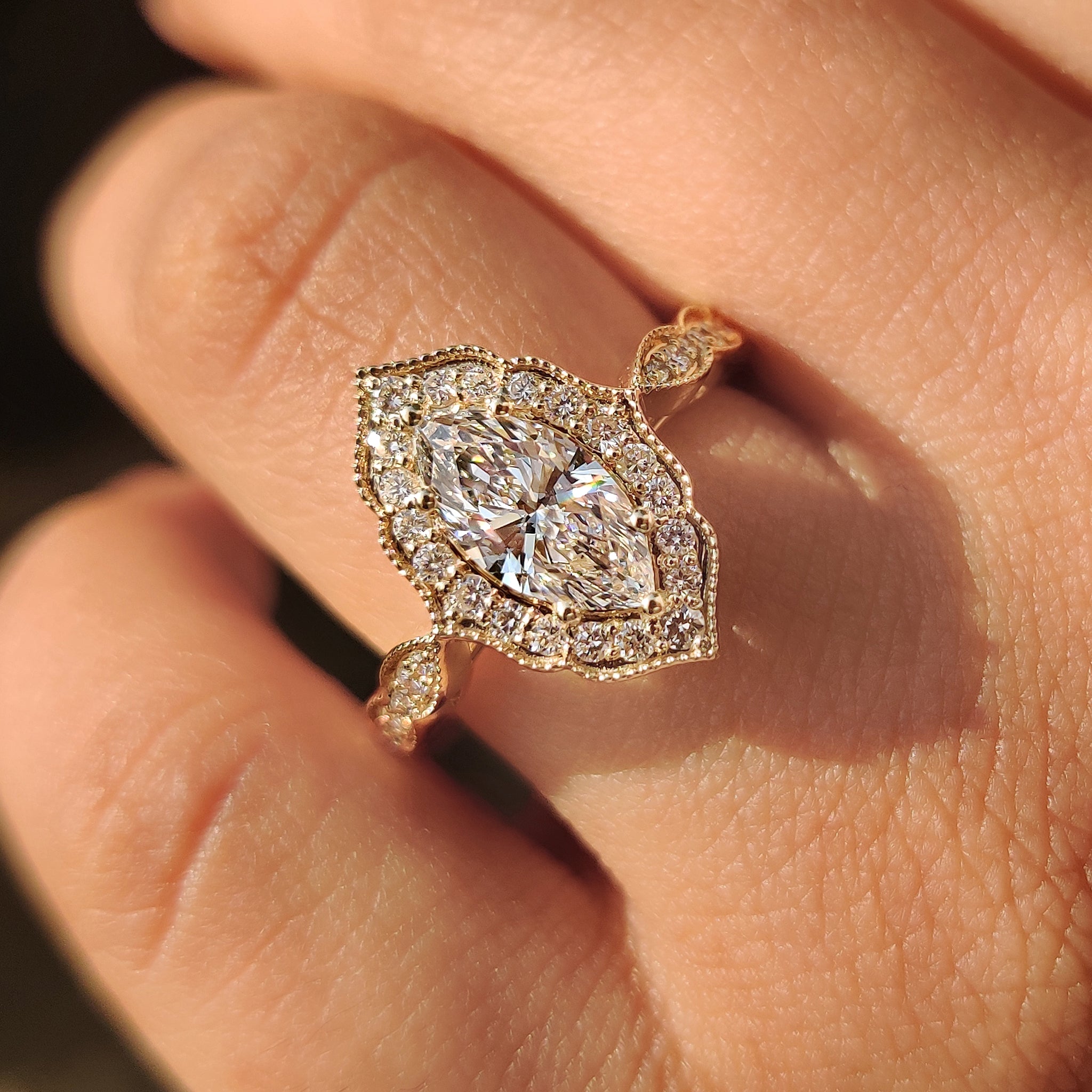 Marquise diamond ring with cathedral and halo setting.
