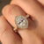 Oval diamond ring with cathedral and halo setting.
