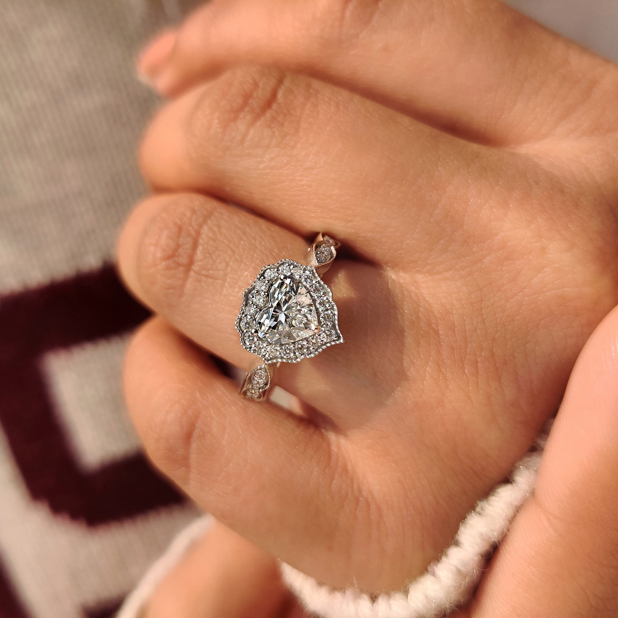 Cathedral style heart cut diamond ring with round halo.
