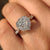 Heart cut diamond ring with cathedral and halo design.
