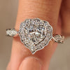 Heart cut diamond ring with halo style and round diamonds.
