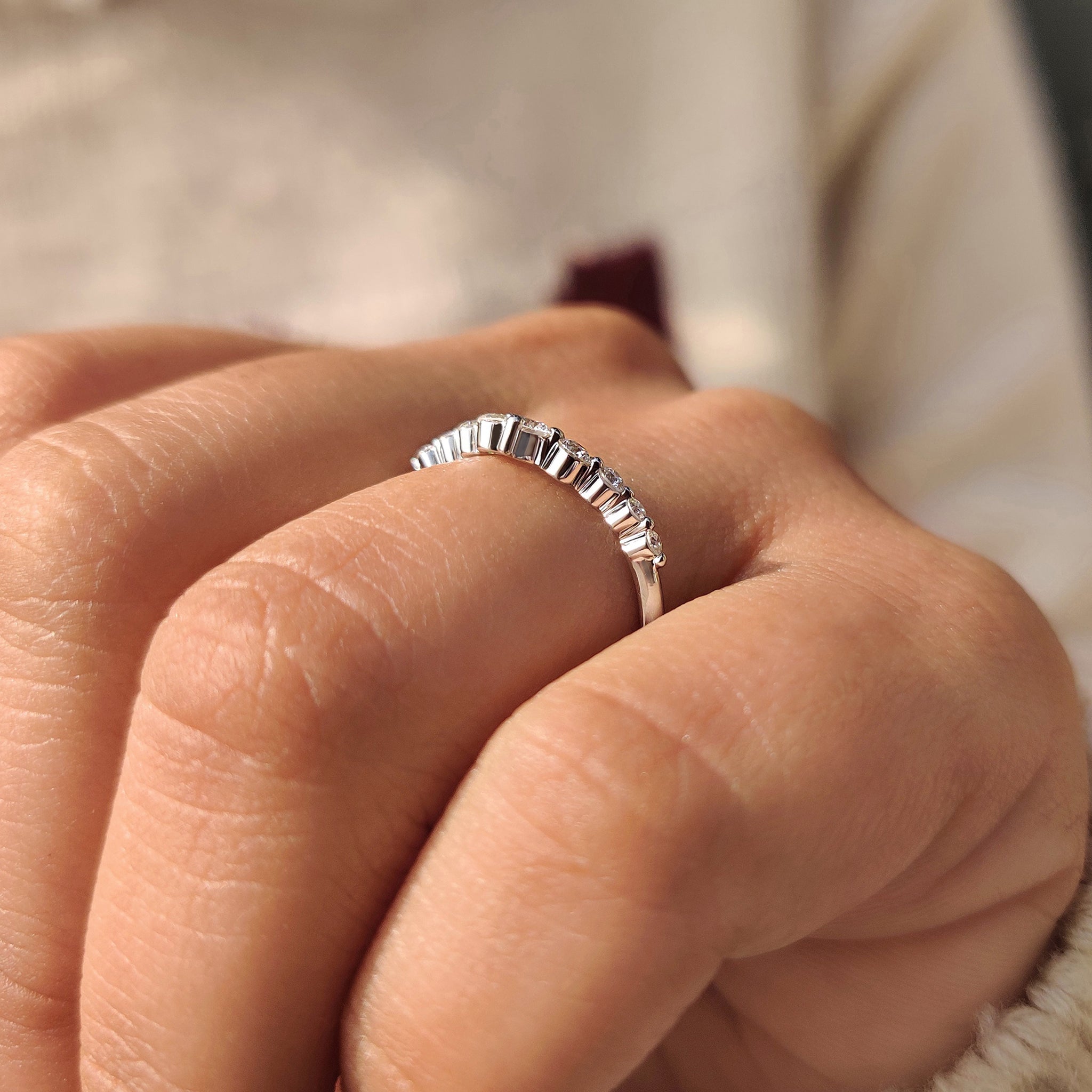 Curved diamond band with shared prong style.
