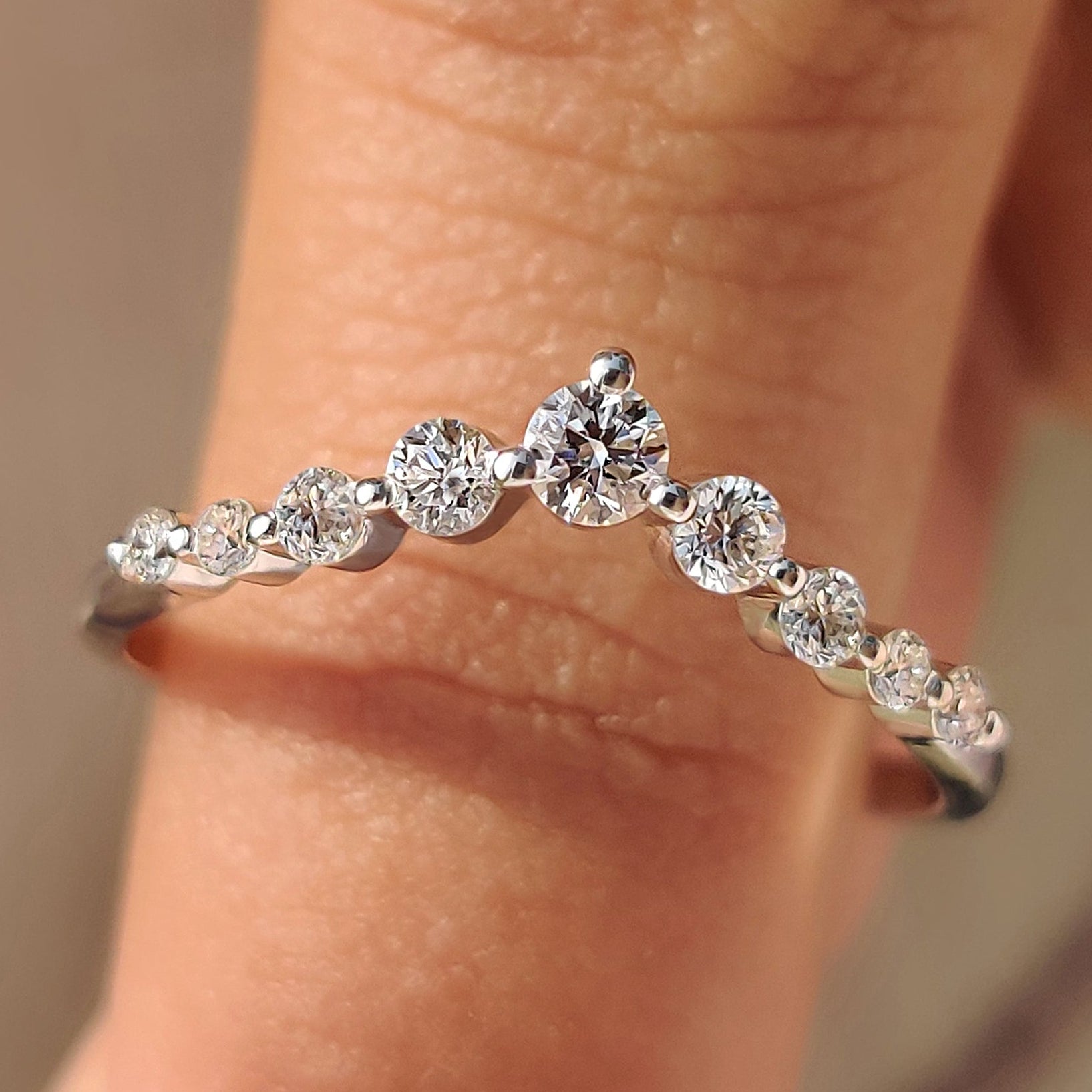 Curved diamond wedding band with round diamonds.
