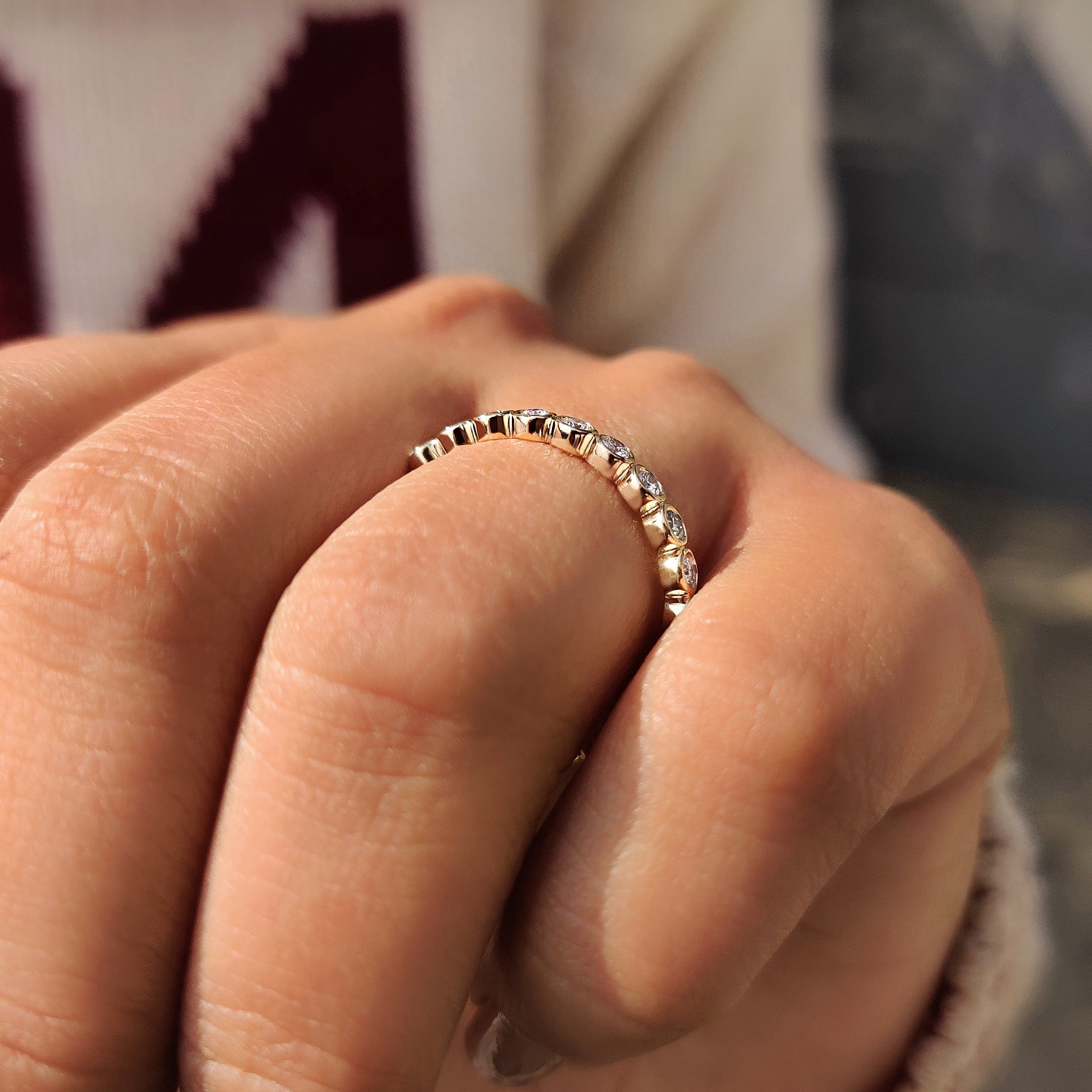 Full eternity round diamond band in bezel setting.
