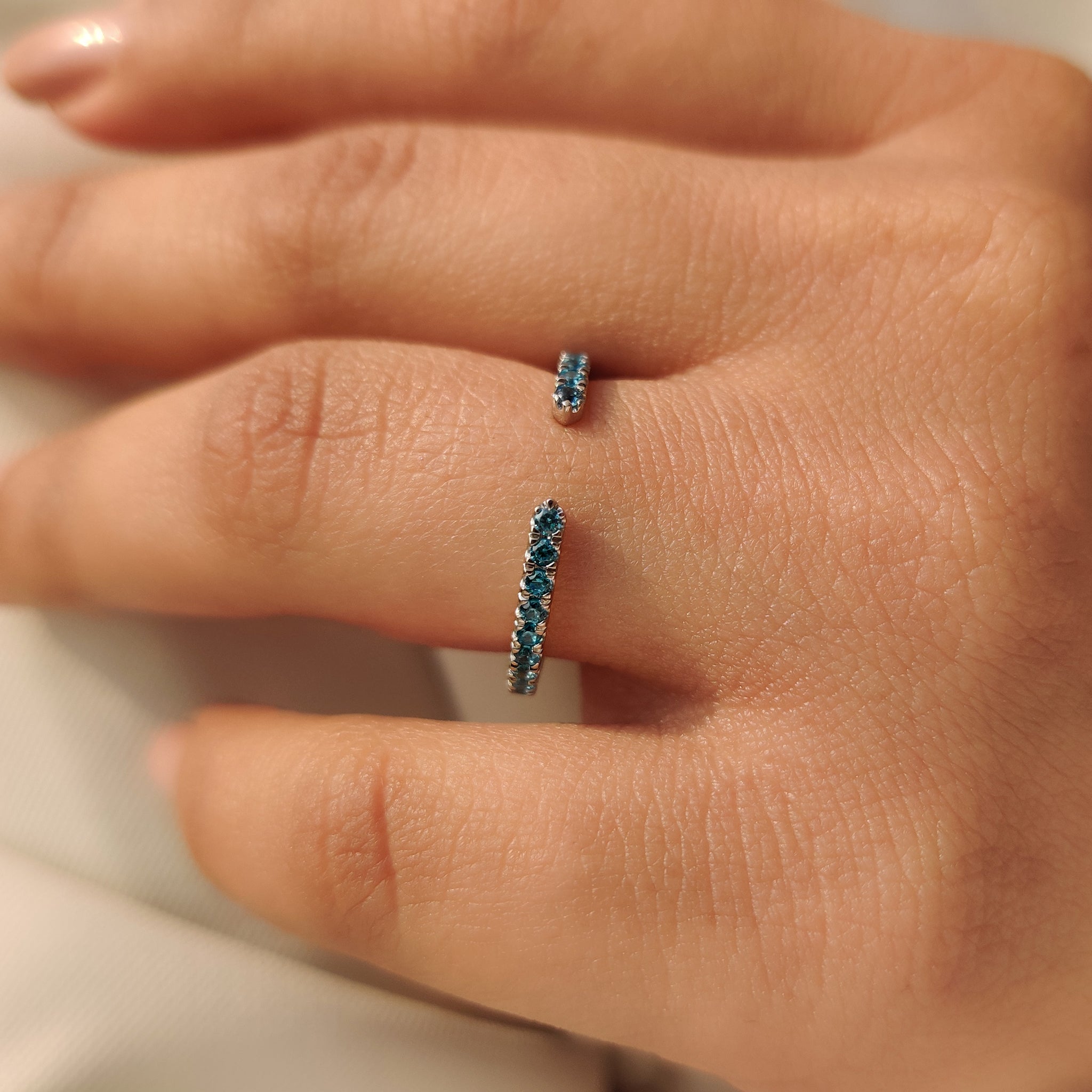 Blue diamond wedding band in 3/4 eternity style.
