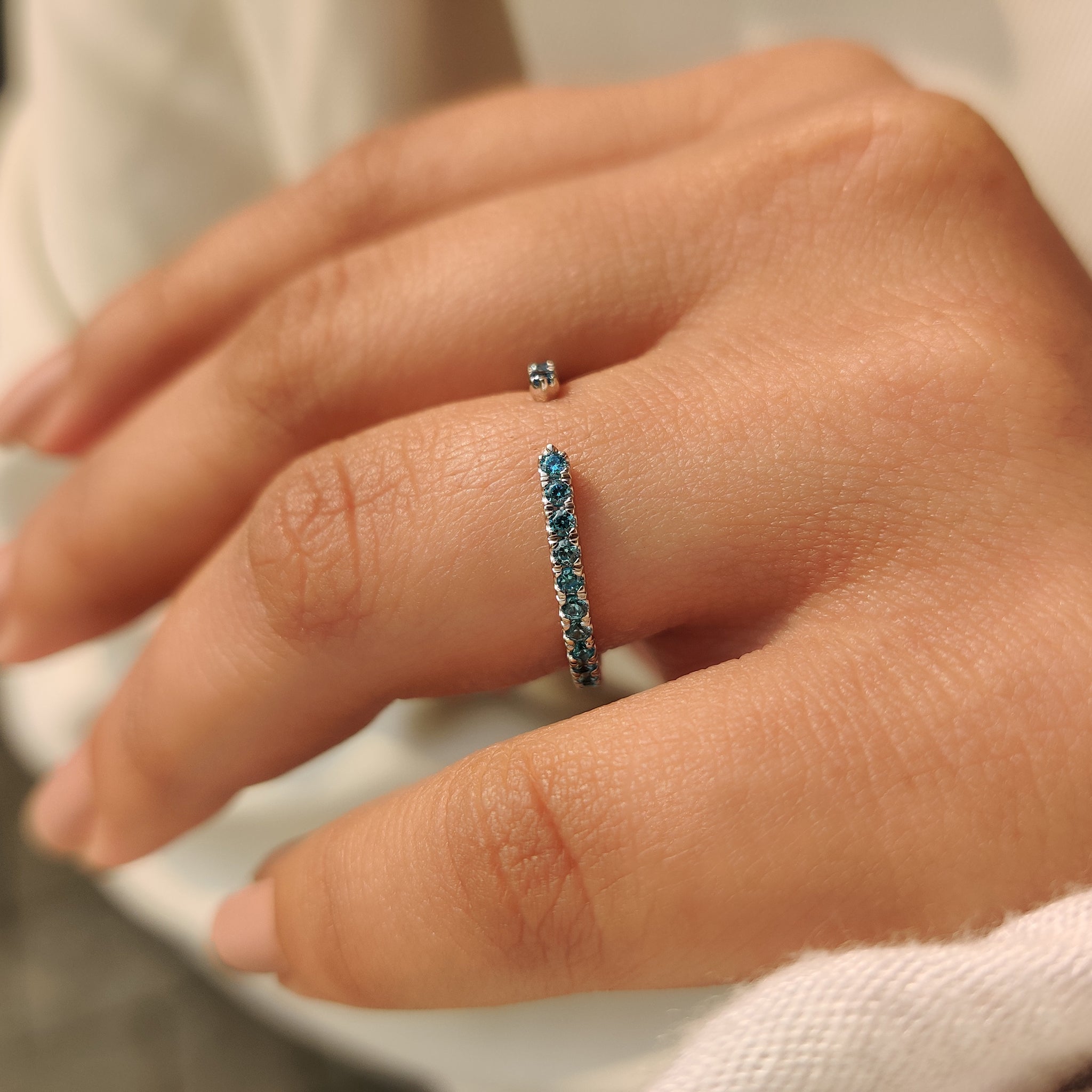 Lab grown blue diamond band with open gap design.
