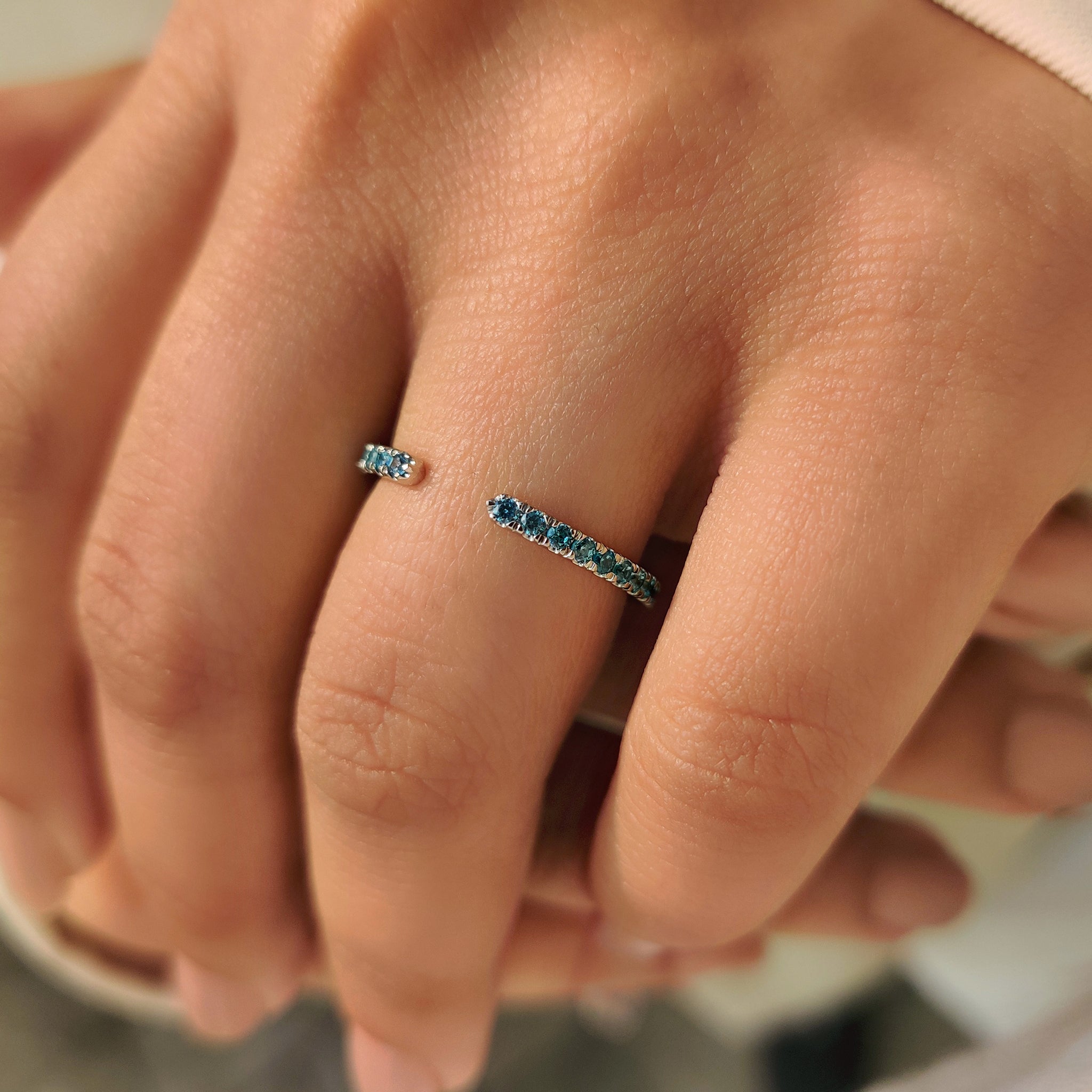 Blue diamond wedding band featuring round cut stones.
