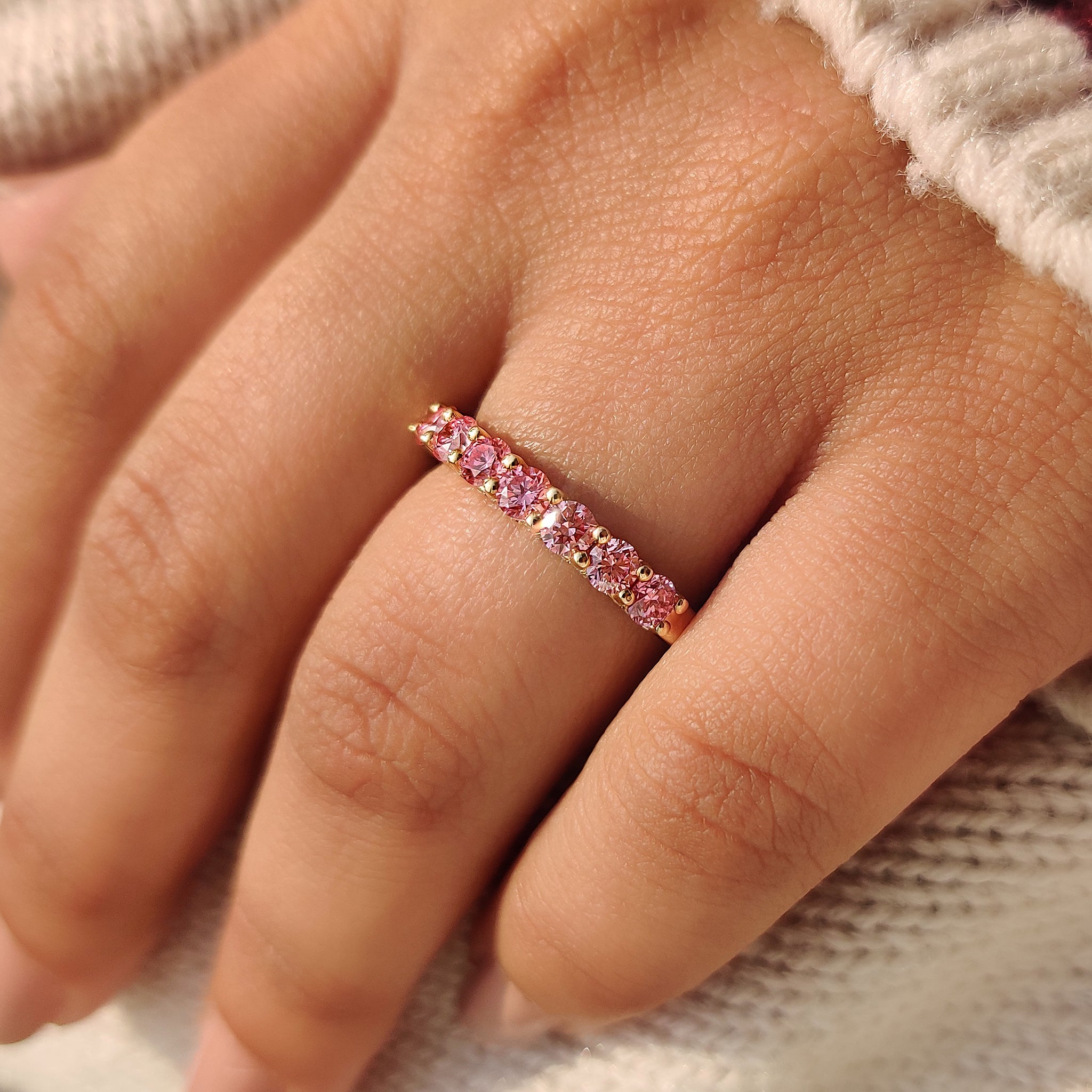 Lab grown pink diamond wedding band half eternity style.
