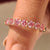 Round diamond wedding band with pink diamonds half eternity.
