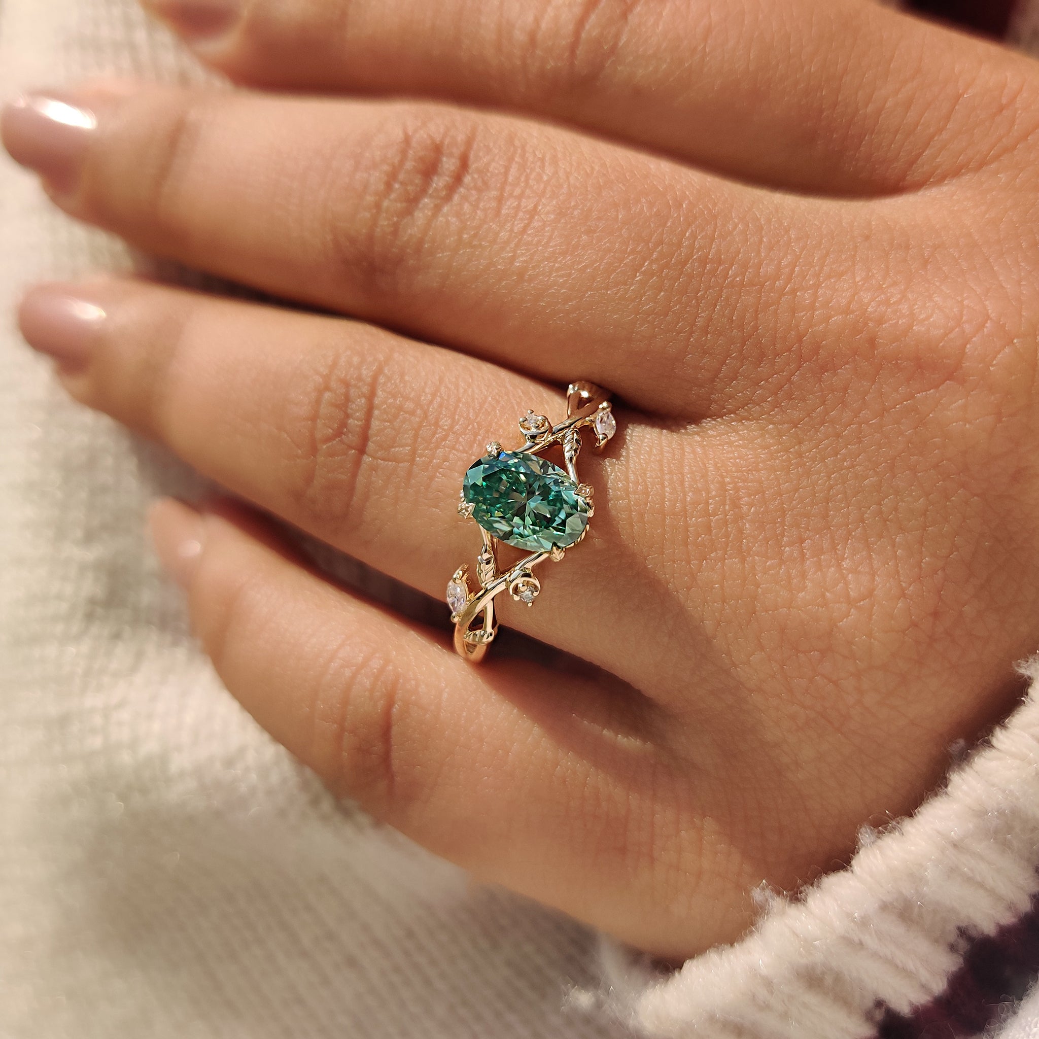 Nature inspired oval moissanite ring with five stone design.
