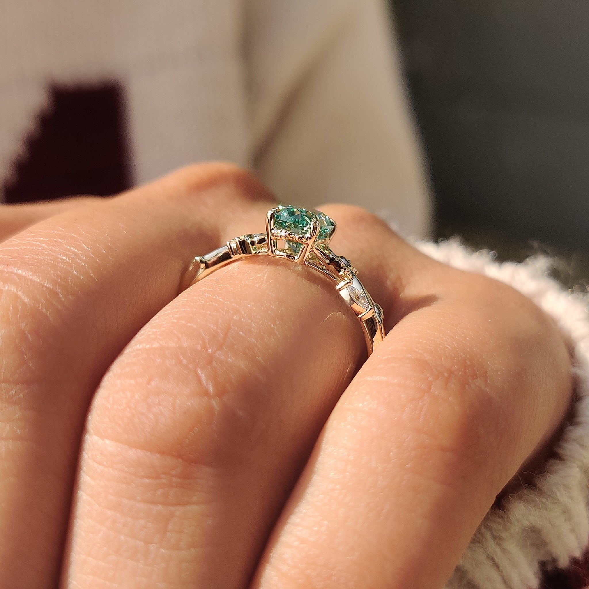 Oval cut moissanite ring with leaf style prong setting.
