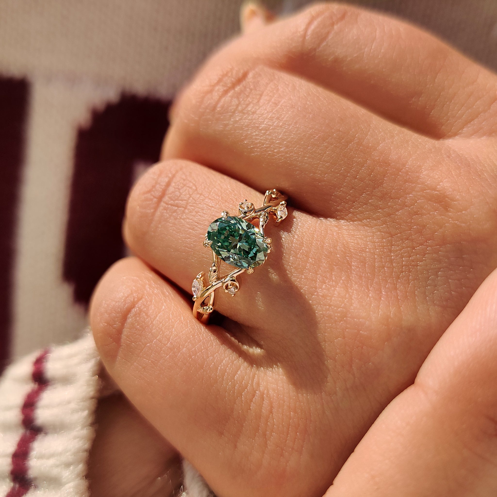 Carat Diamonds handmade oval cut green moissanite ring.