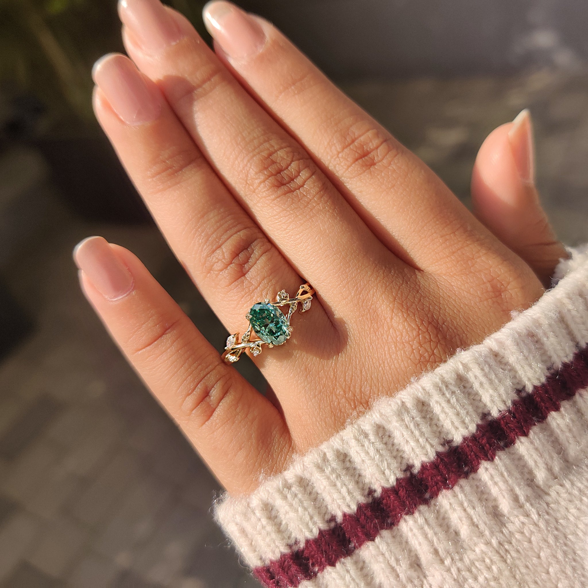 Green moissanite ring with organic nature inspired details.
