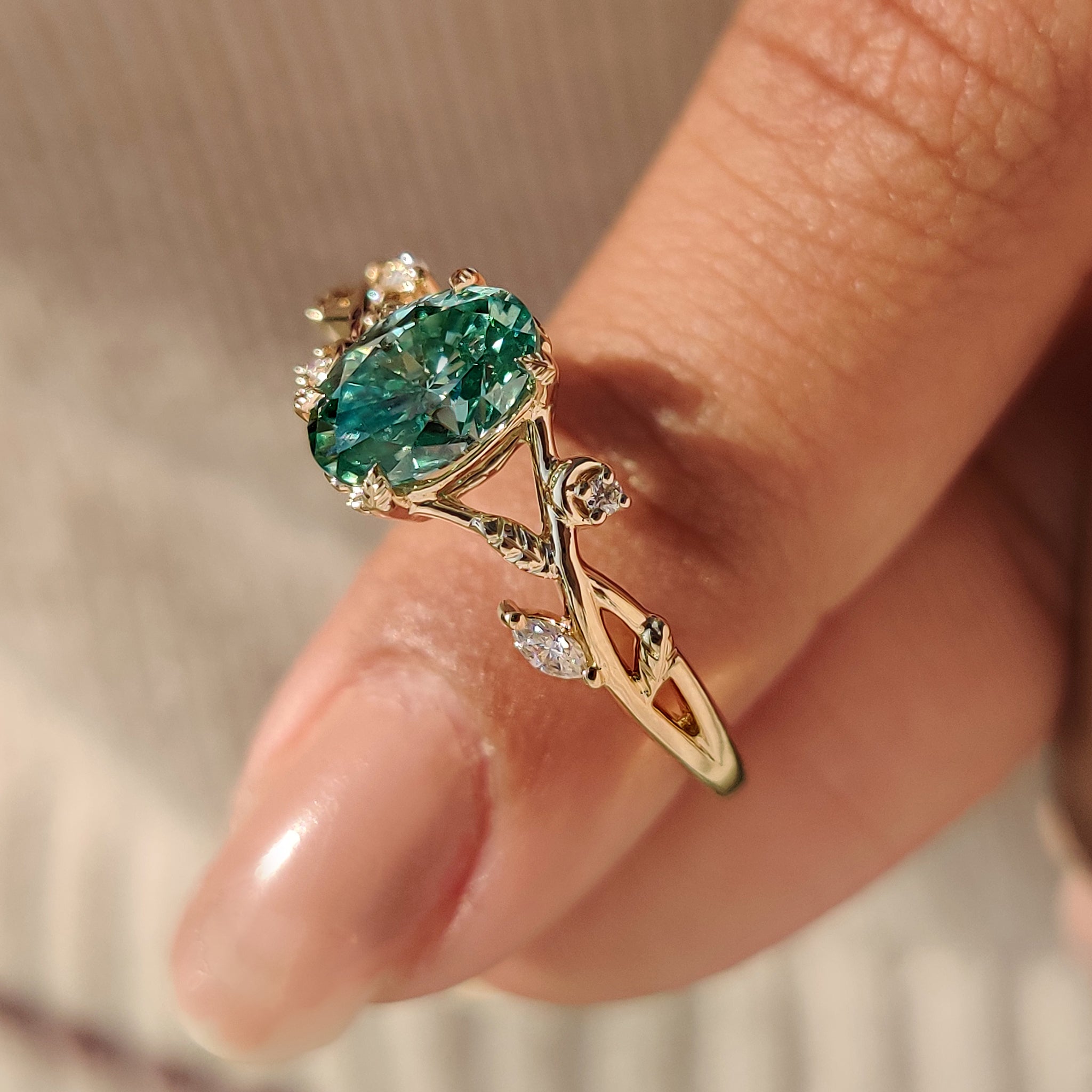 Handmade oval cut green moissanite ring with side stones.
