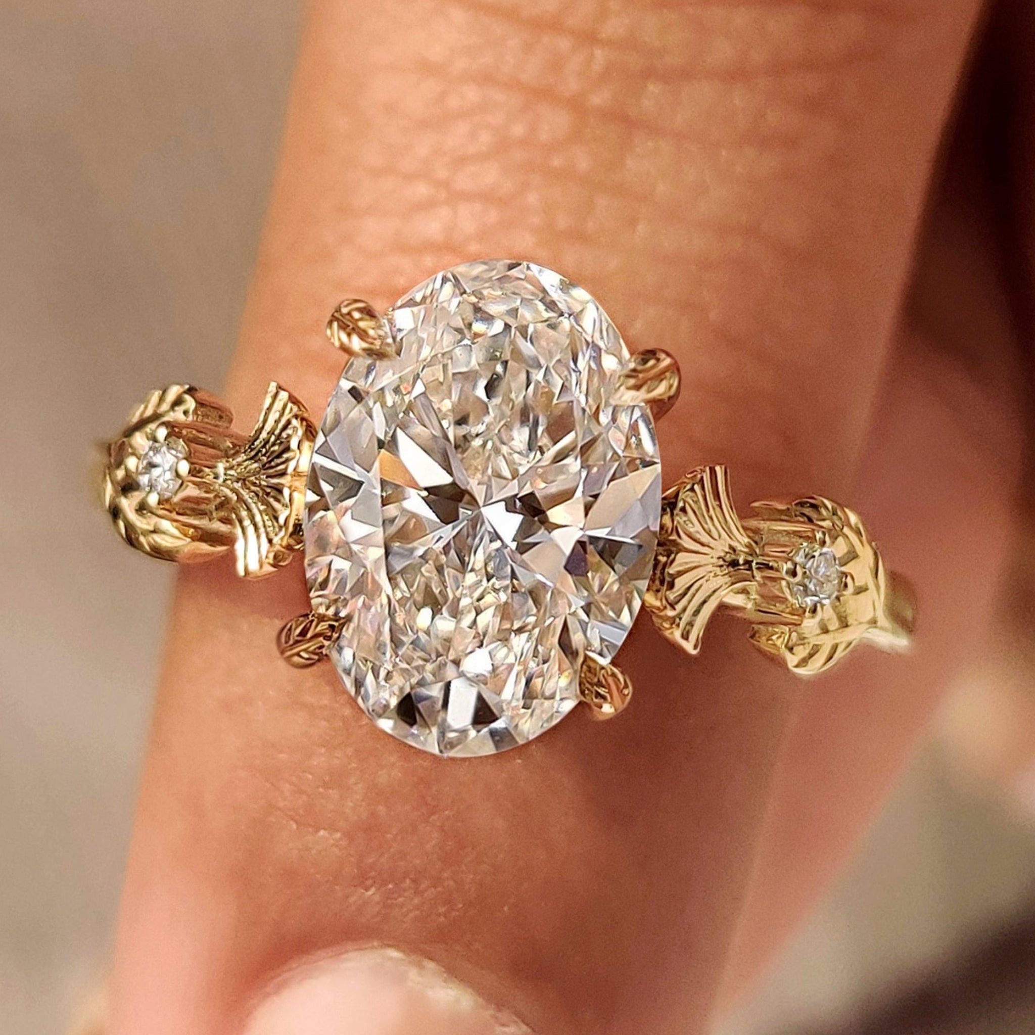 Oval diamond ring with nature inspired leaf style prong
