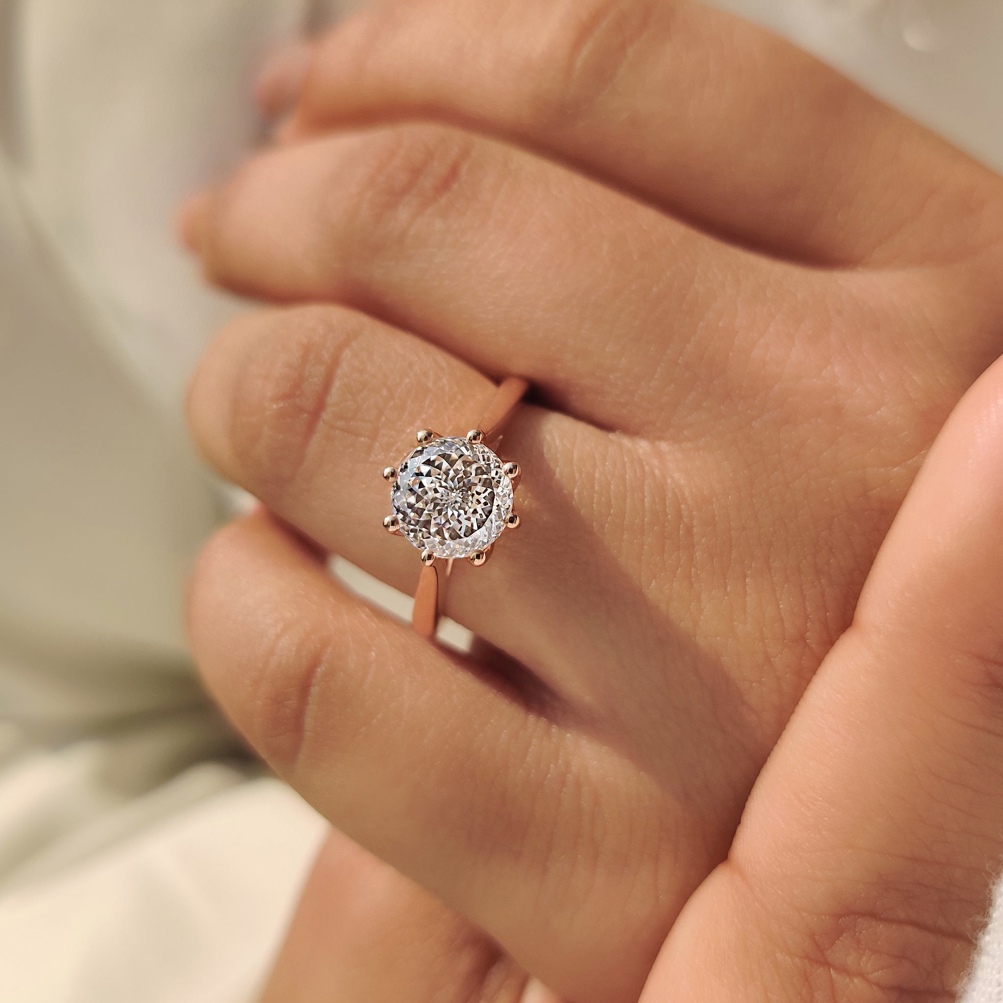 Solitaire style Portuguese cut diamond ring with tulip design
