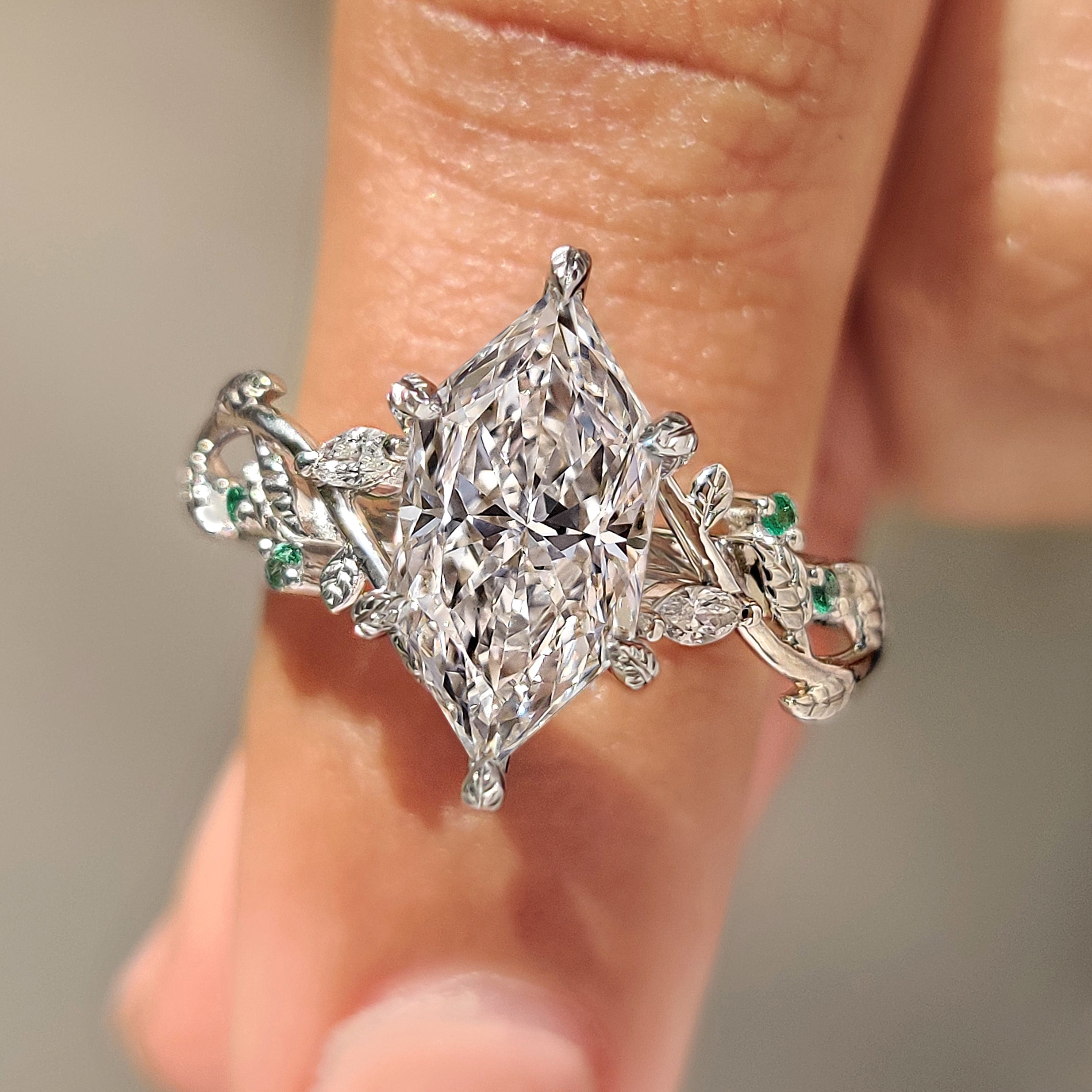 Dutch marquise diamond ring with green emerald gemstone accents
