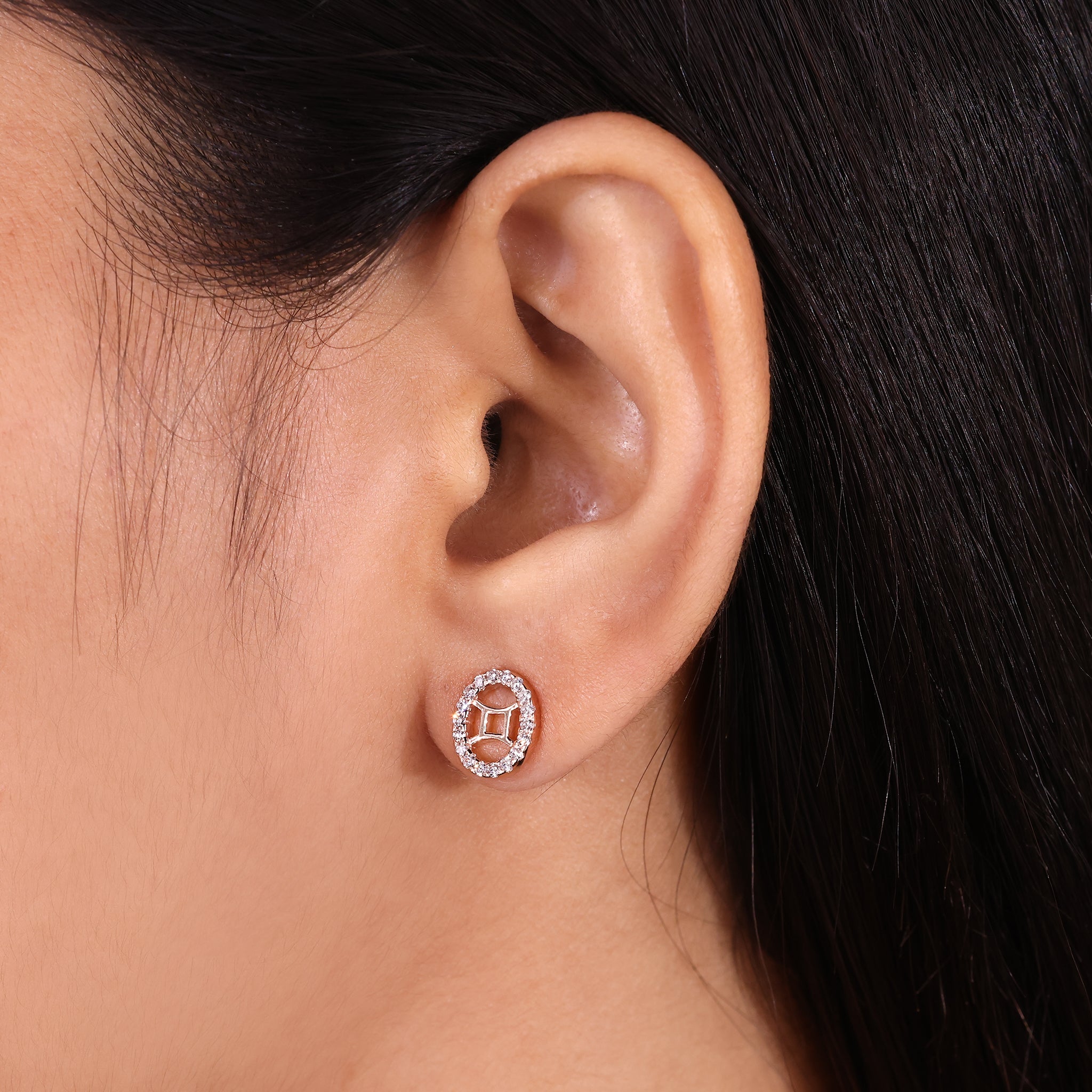 Carat Diamonds Gemini earrings in rose gold with round halo diamonds.
