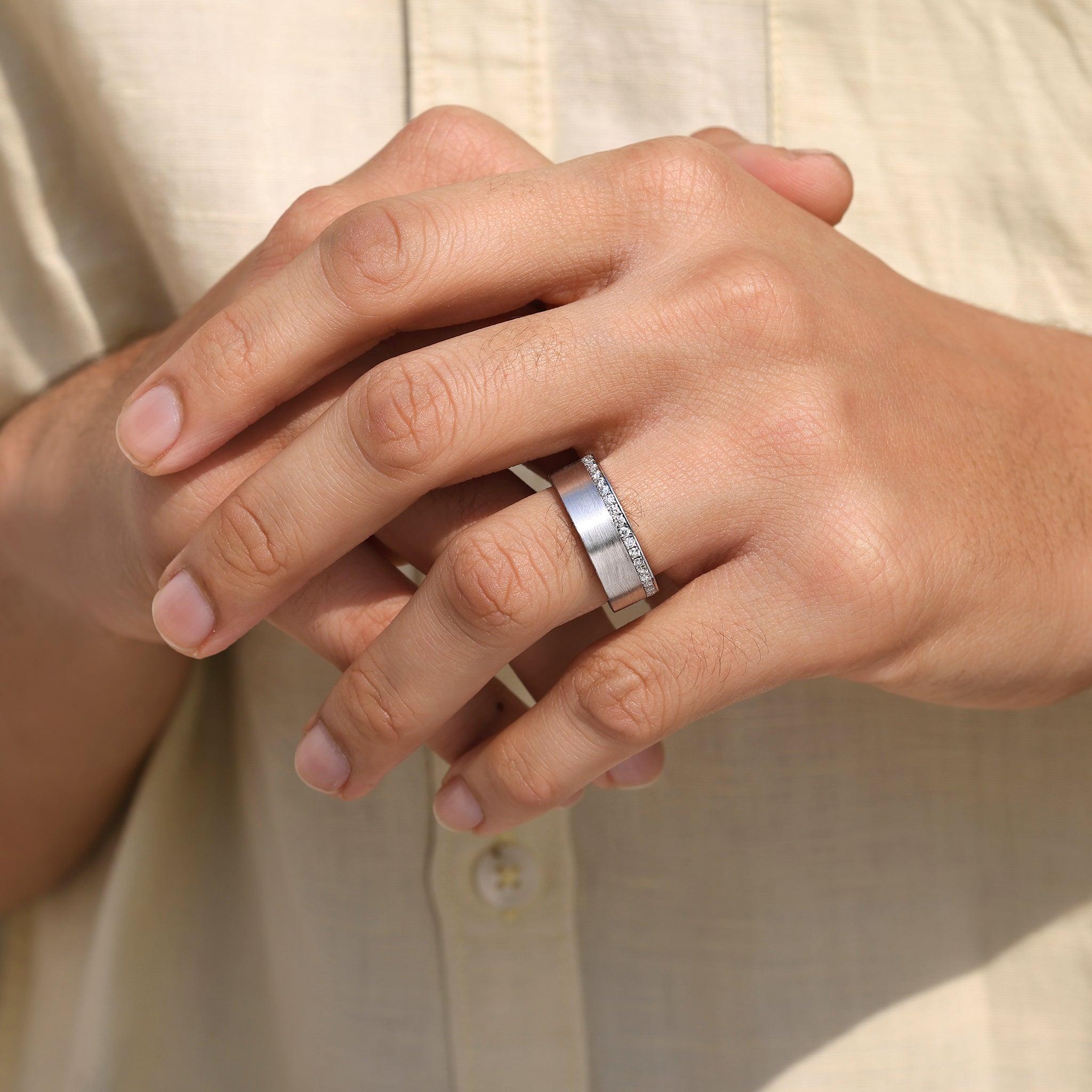 Men’s ring designed with round cut stones and hidden pave.
