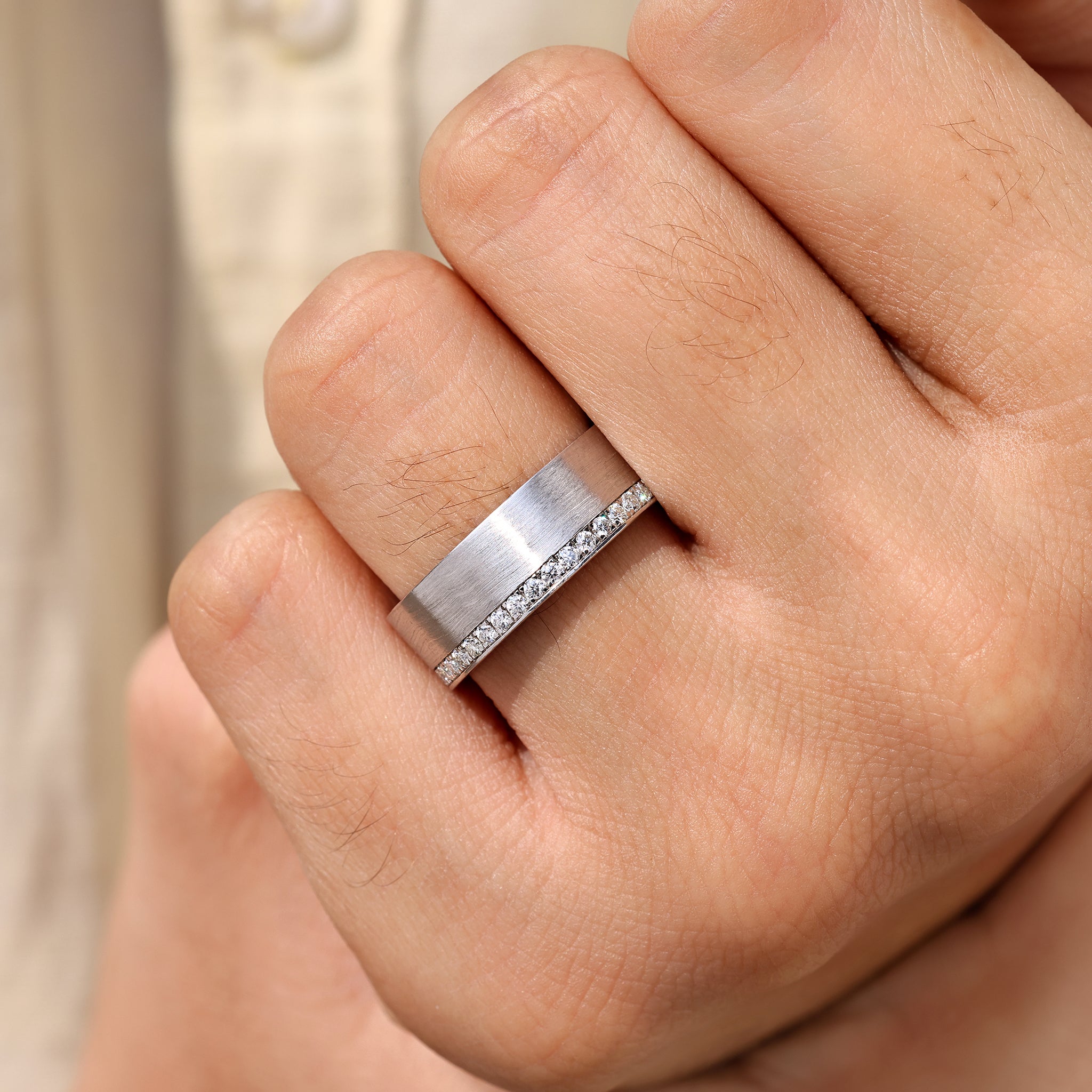 Men’s ring featuring round cut stones and matte finish.
