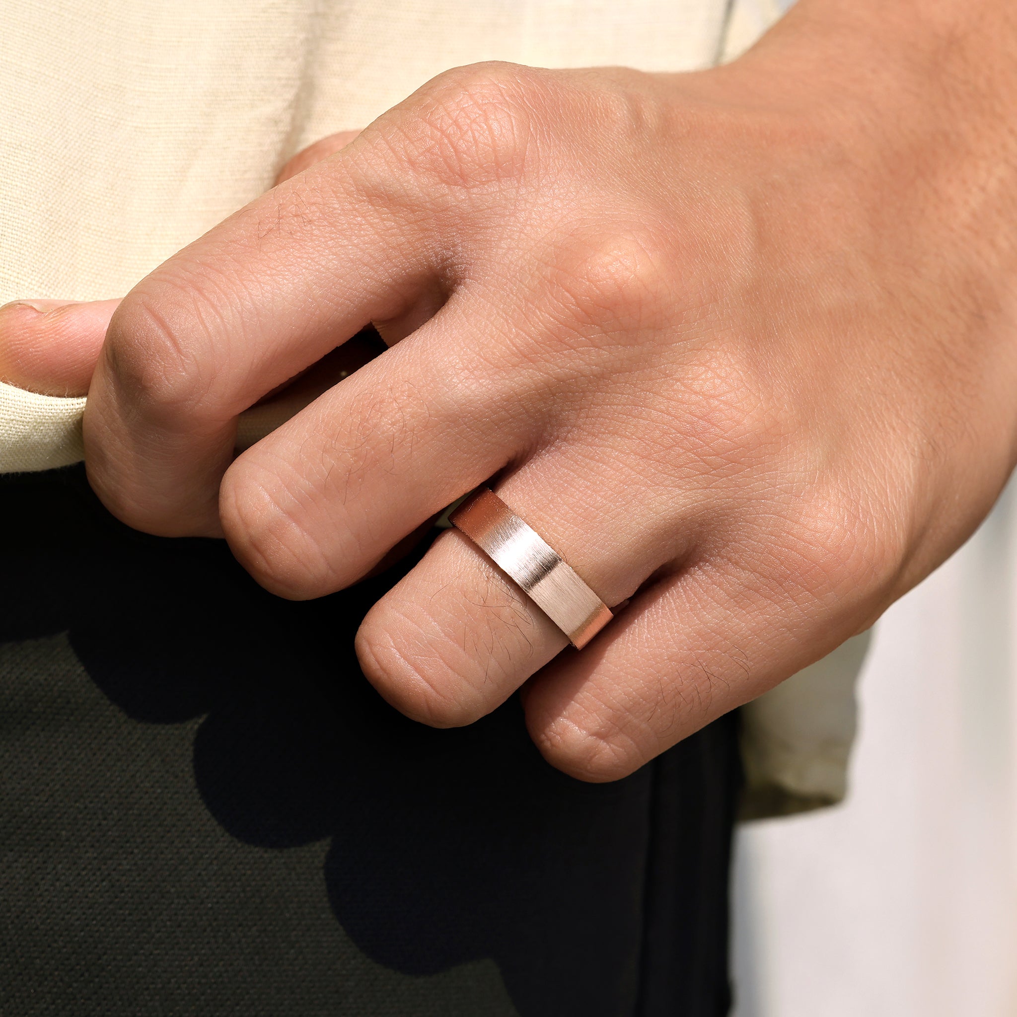 Men’s eternity ring with round cut stones on both sides.
