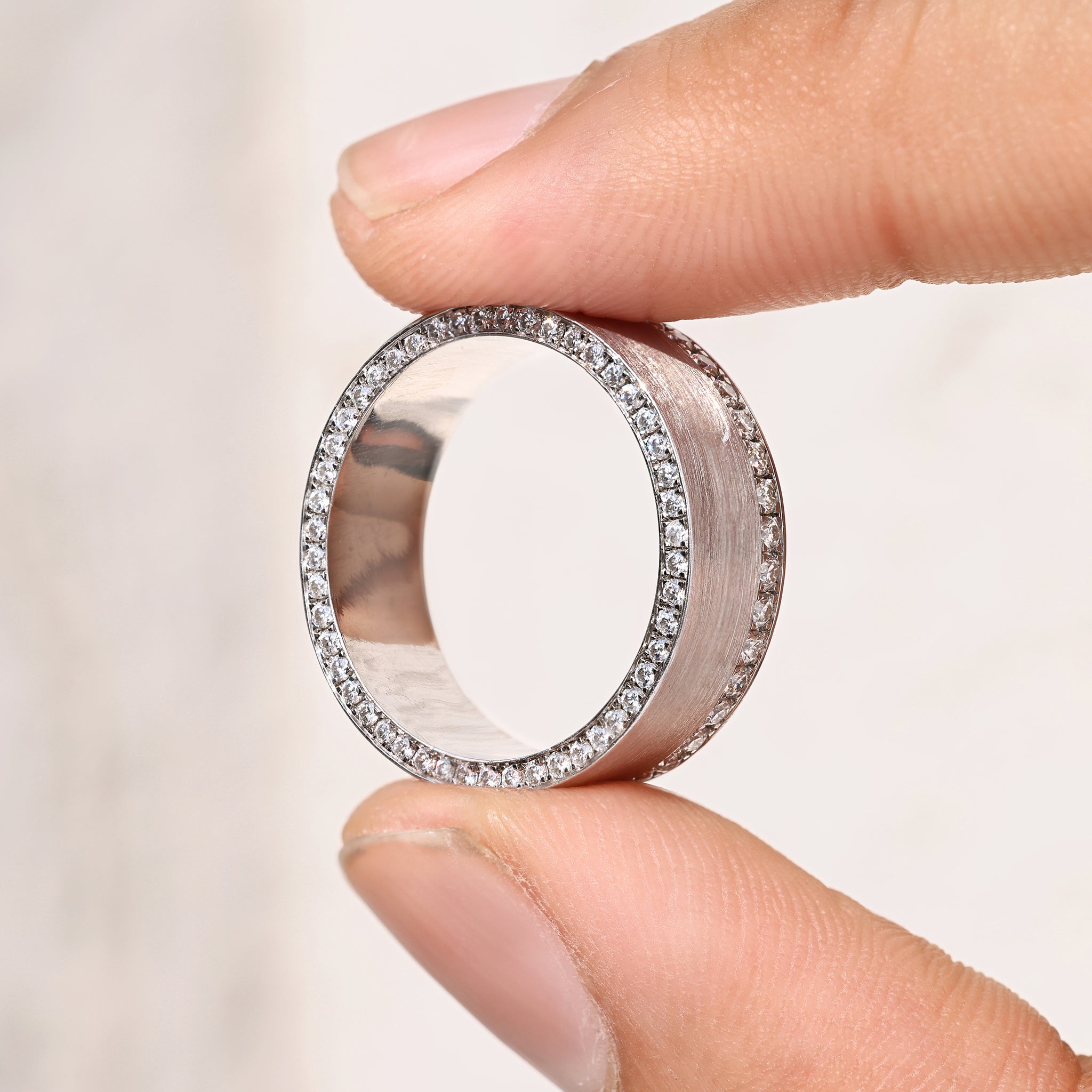 Men’s round cut ring with matte finish and pave setting.
