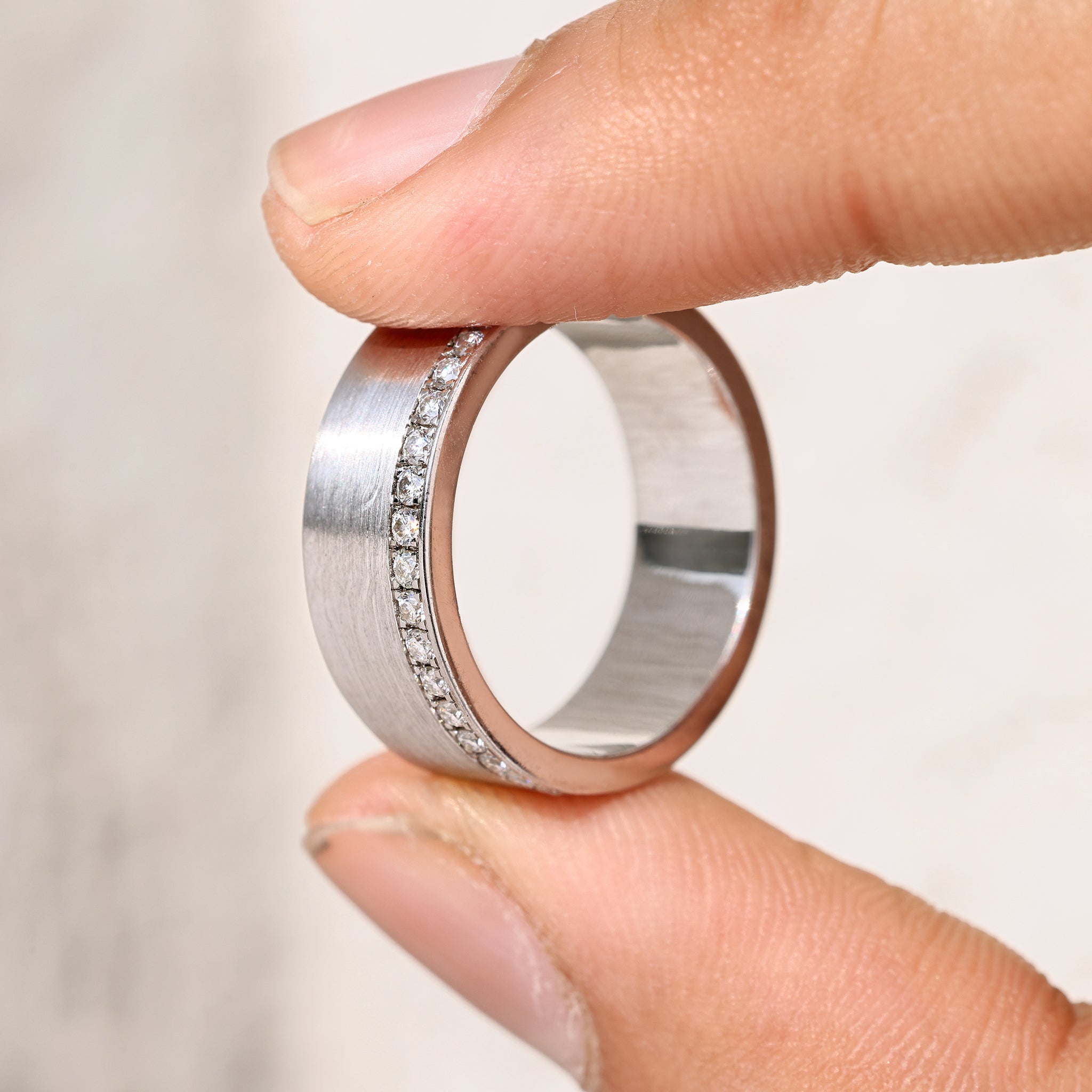 Round cut men’s ring with pave and hidden pave design.
