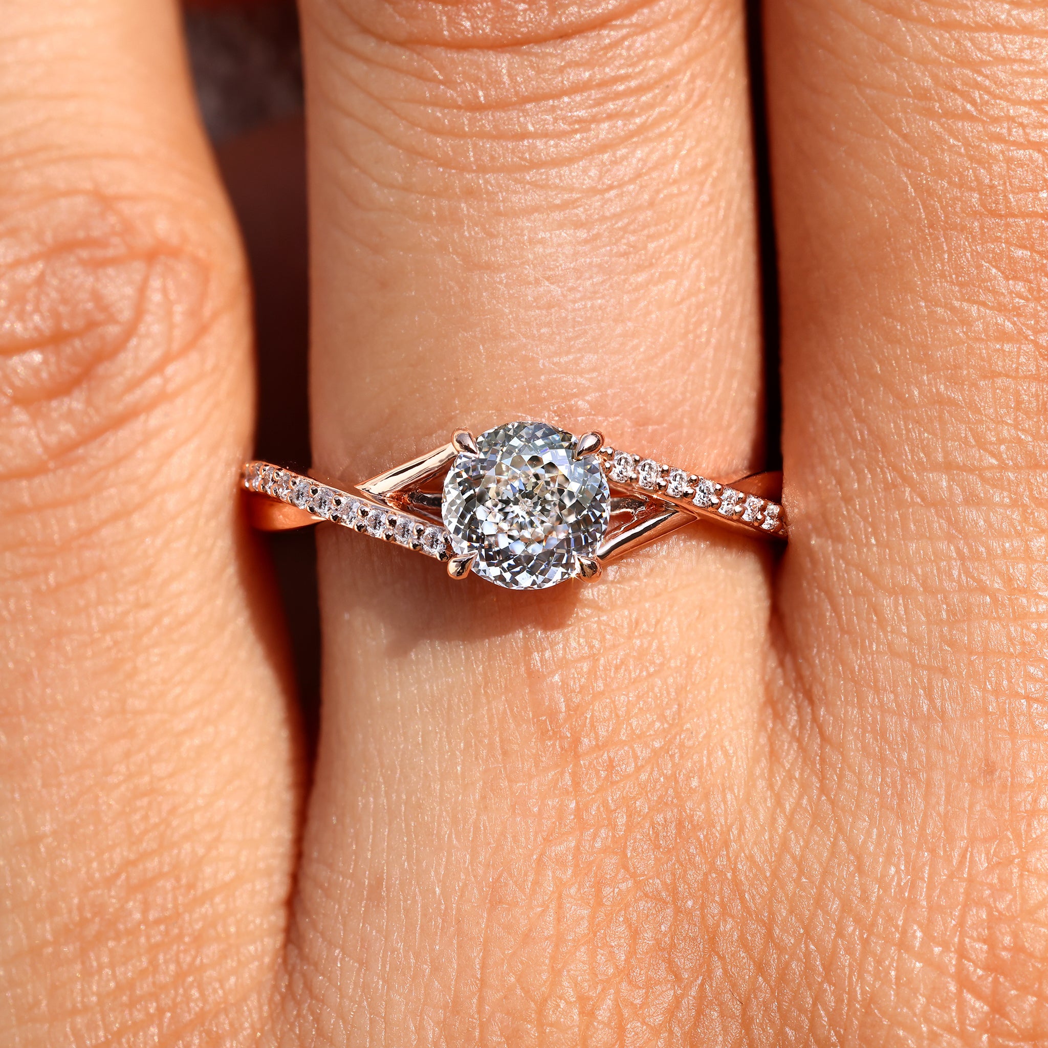 Twisted shank four claw prong diamond ring.
