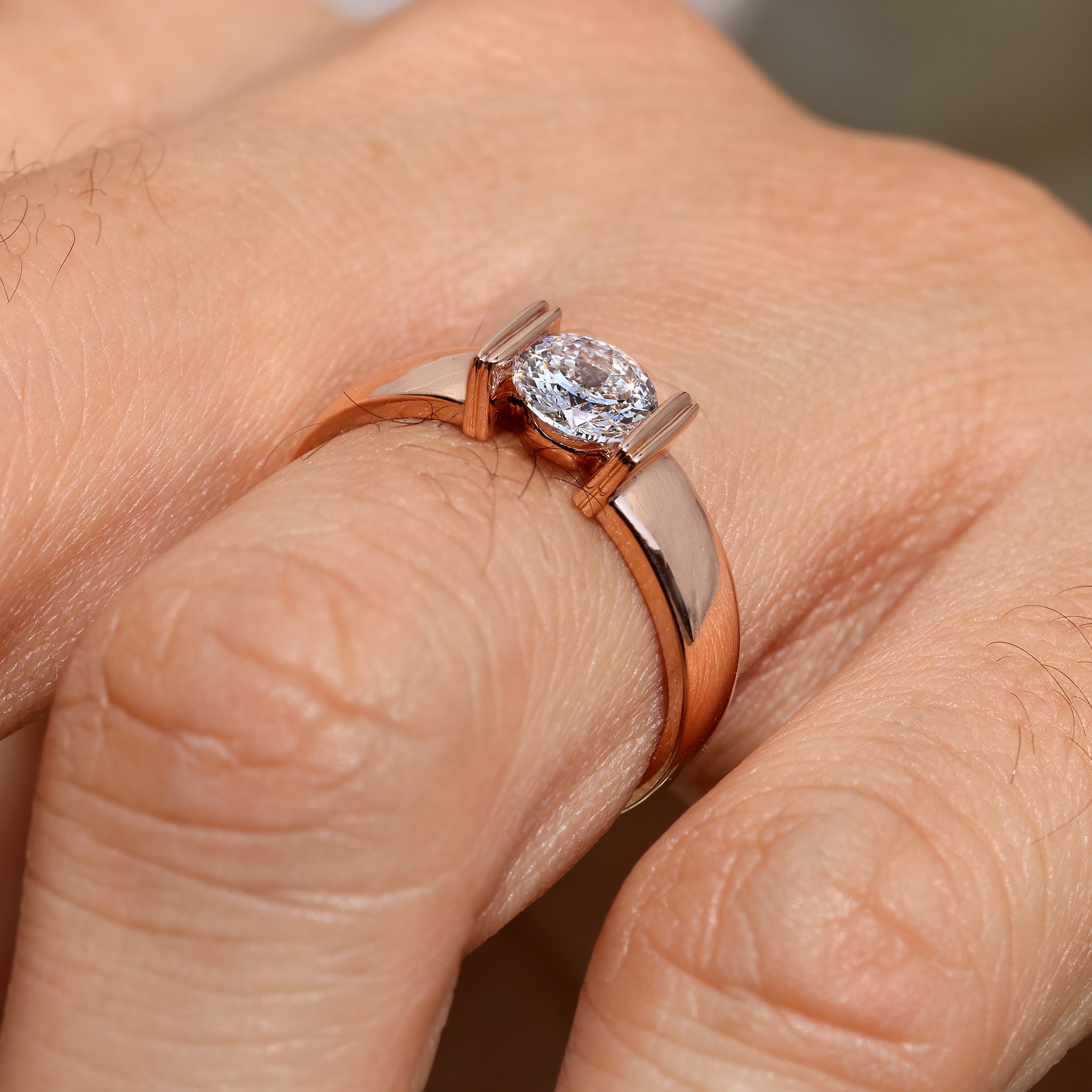 Men’s solitaire ring with tapered shank and tension setting.
