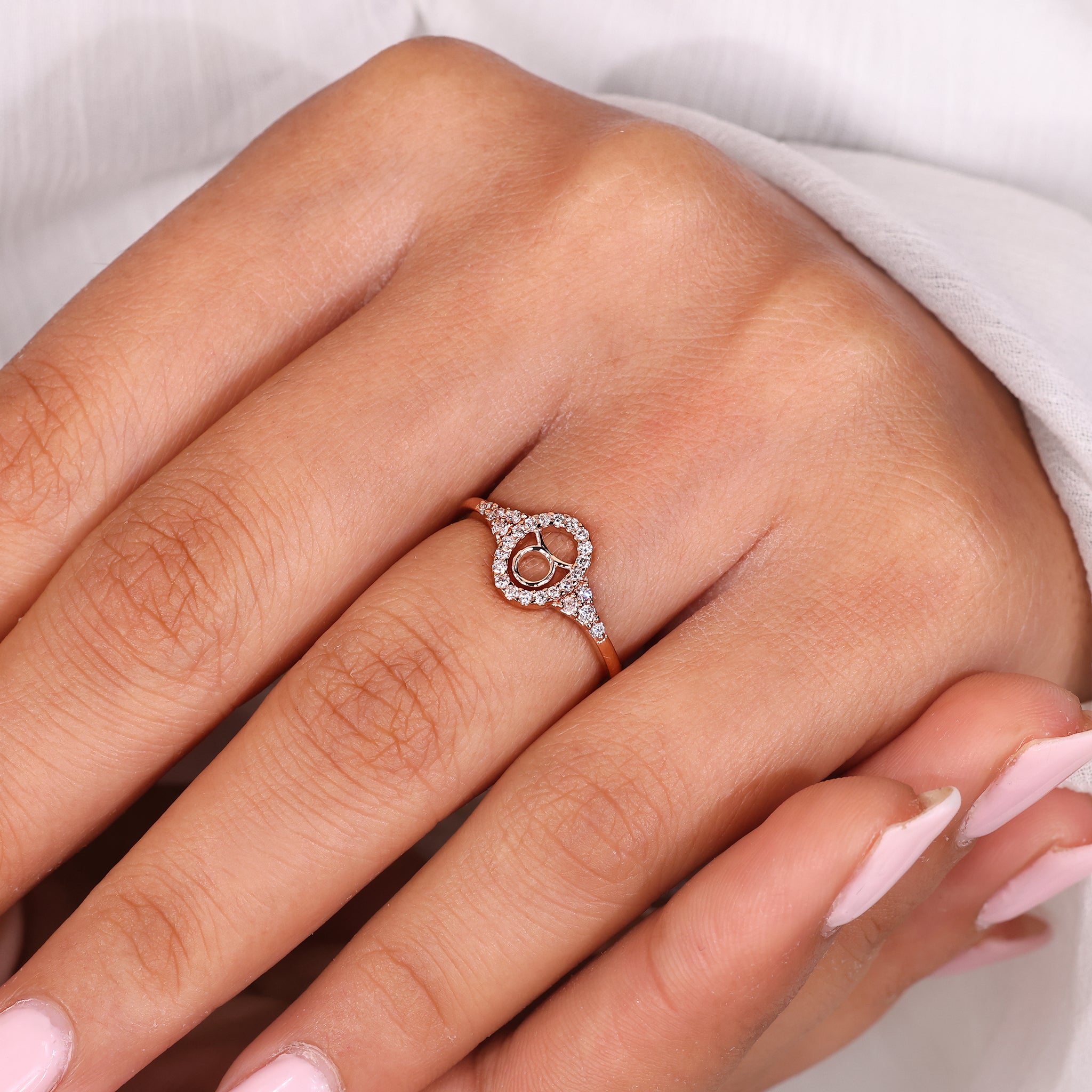 Gold Taurus ring with halo diamond and round cut side stone detailing.
