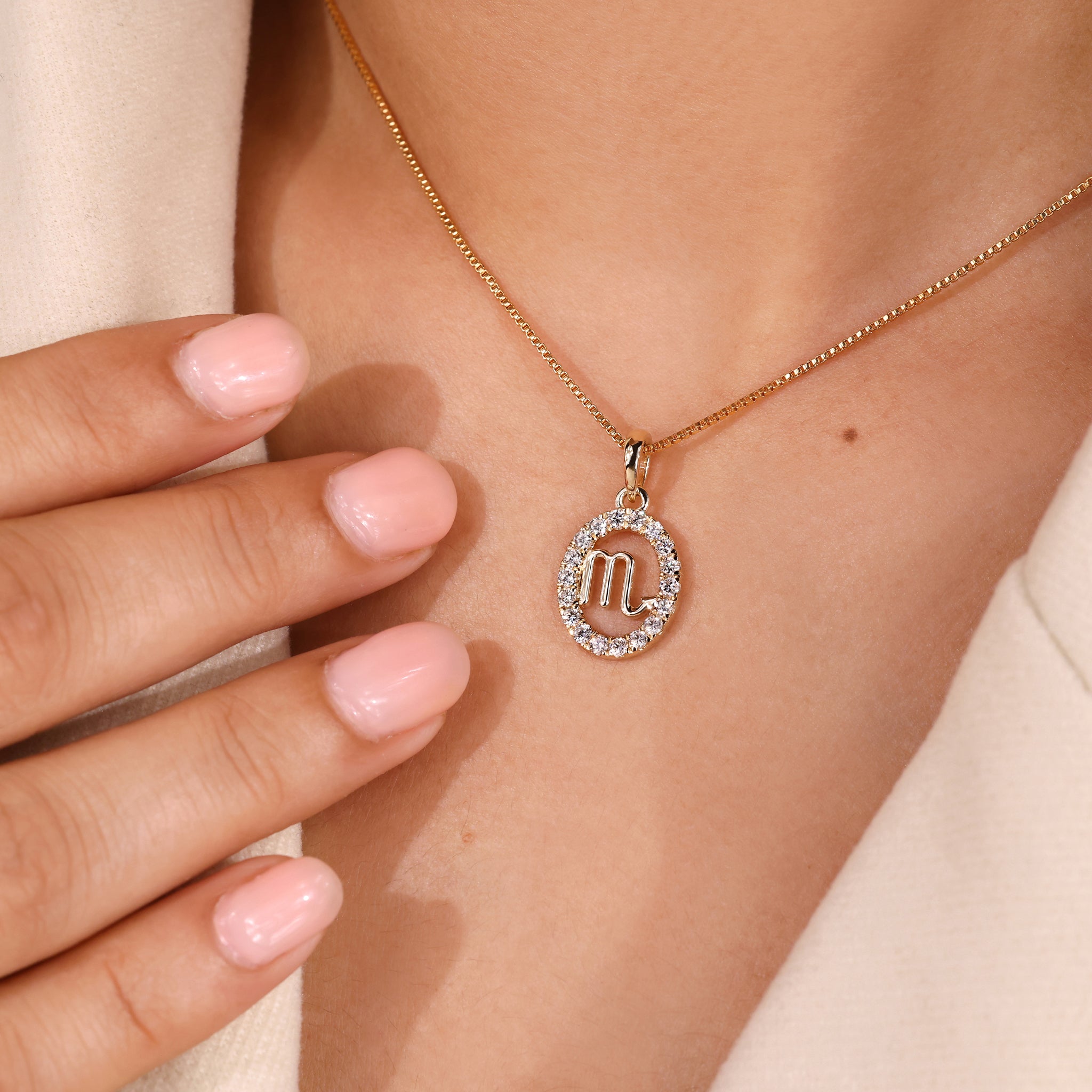 Custom pendant with Scorpio zodiac symbol and halo diamond centerpiece.