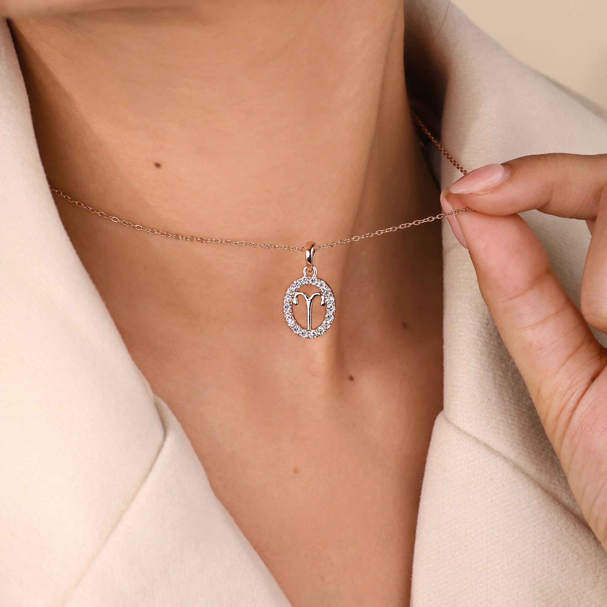 Custom pendant with Aries zodiac symbol and halo diamond centerpiece.