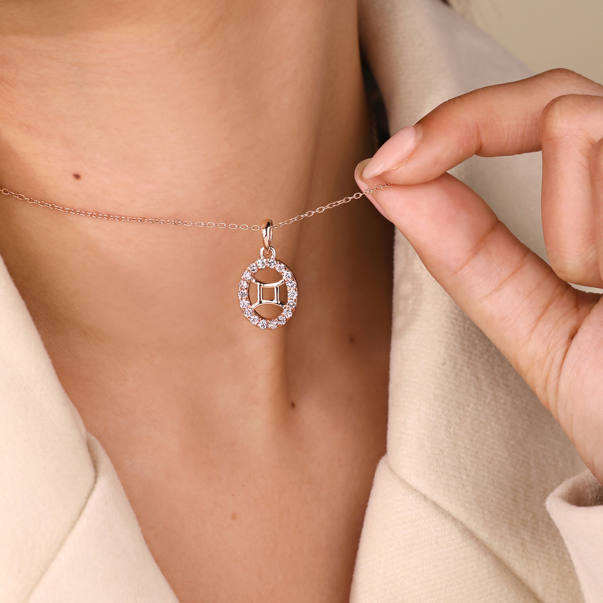 Custom pendant with Gemini zodiac symbol and halo diamond centerpiece.