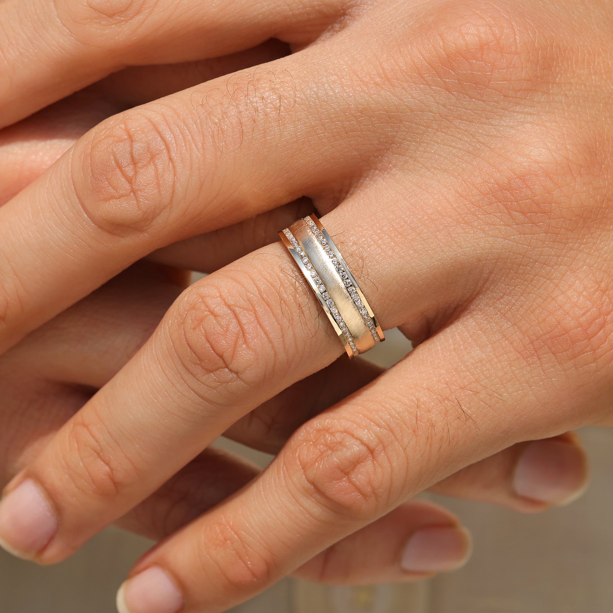 Men’s diamond ring with matte finish and pave rows.
