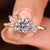 Round diamond engagement ring with marquise side stones.
