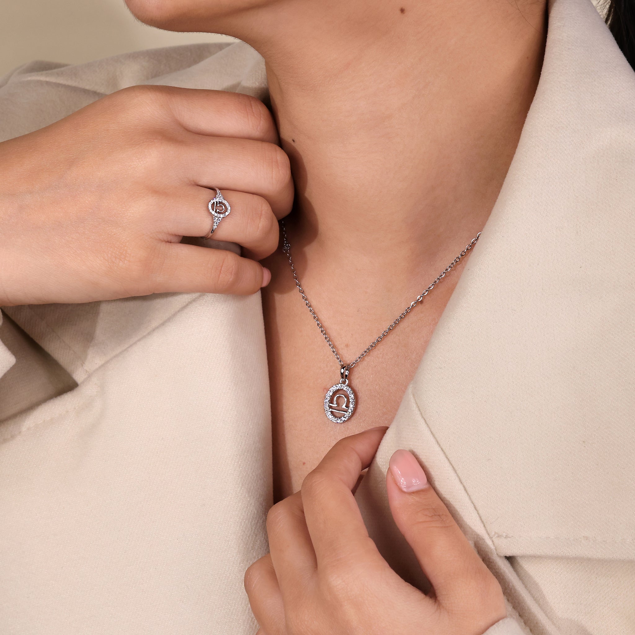 White gold Libra pendant highlighting a halo diamond and zodiac sign.