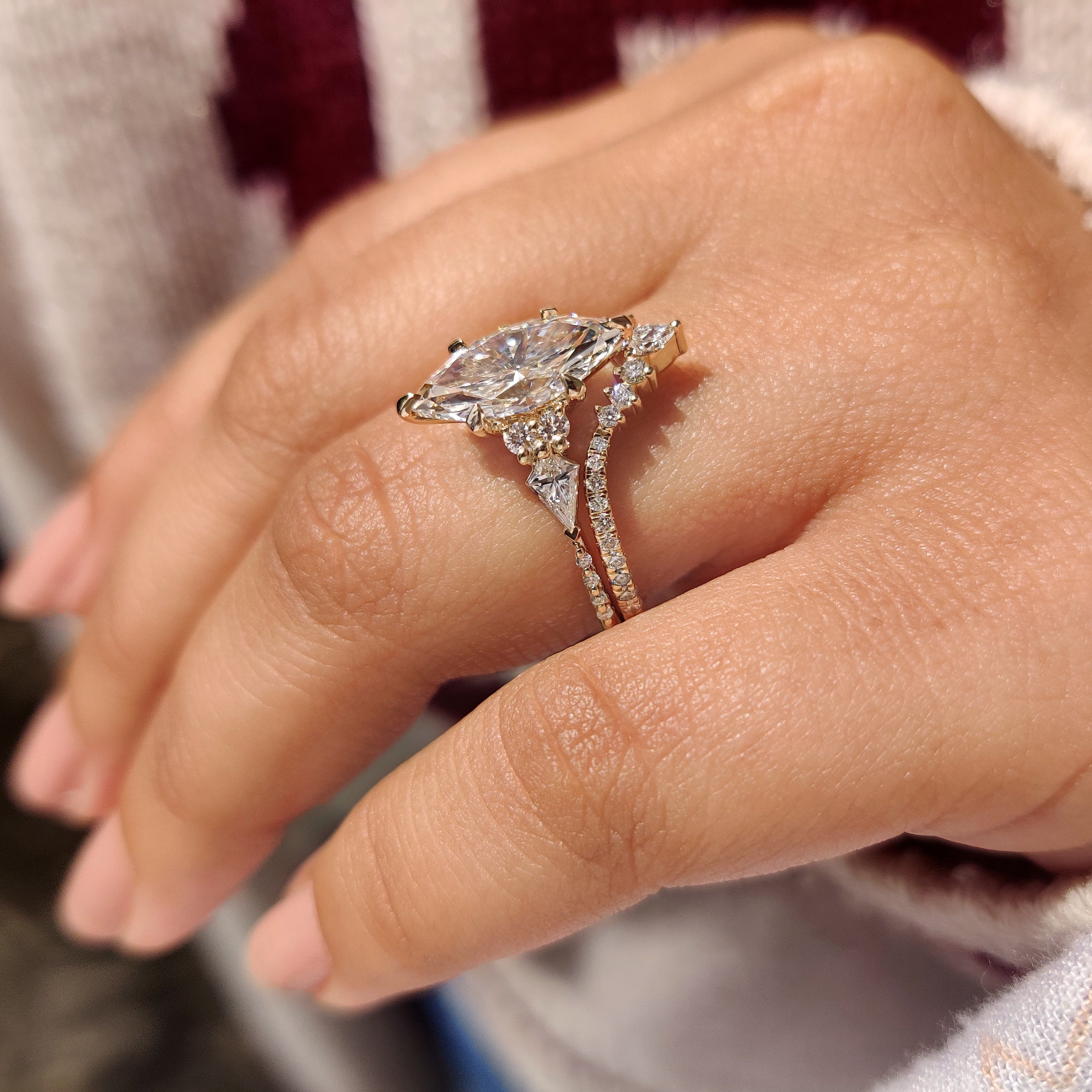 Marquise diamond ring set with pear and round accents.
