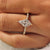 V shaped prongs holding the pointed ends of a kite cut diamond.
