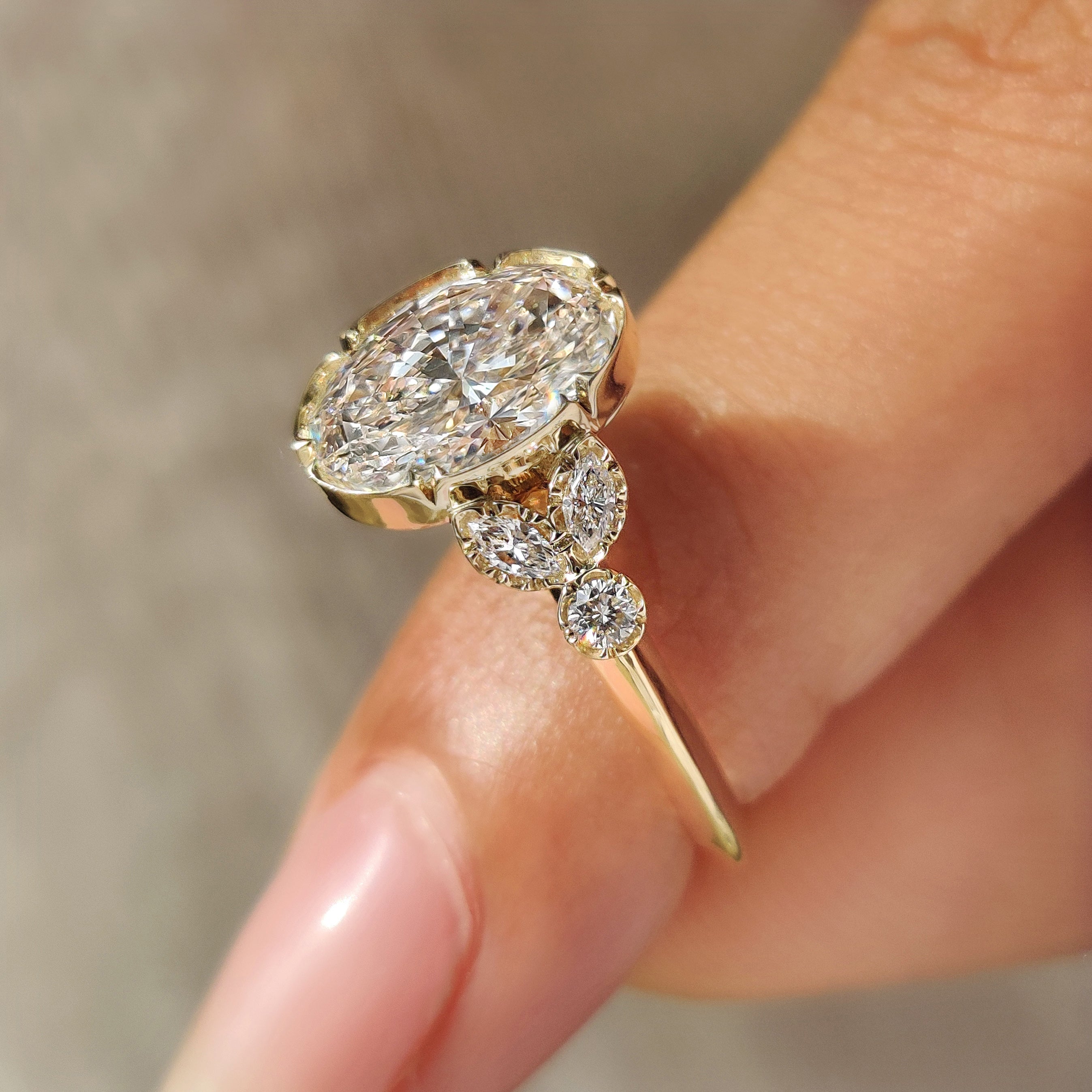 Oval ring with marquise and round side stones
