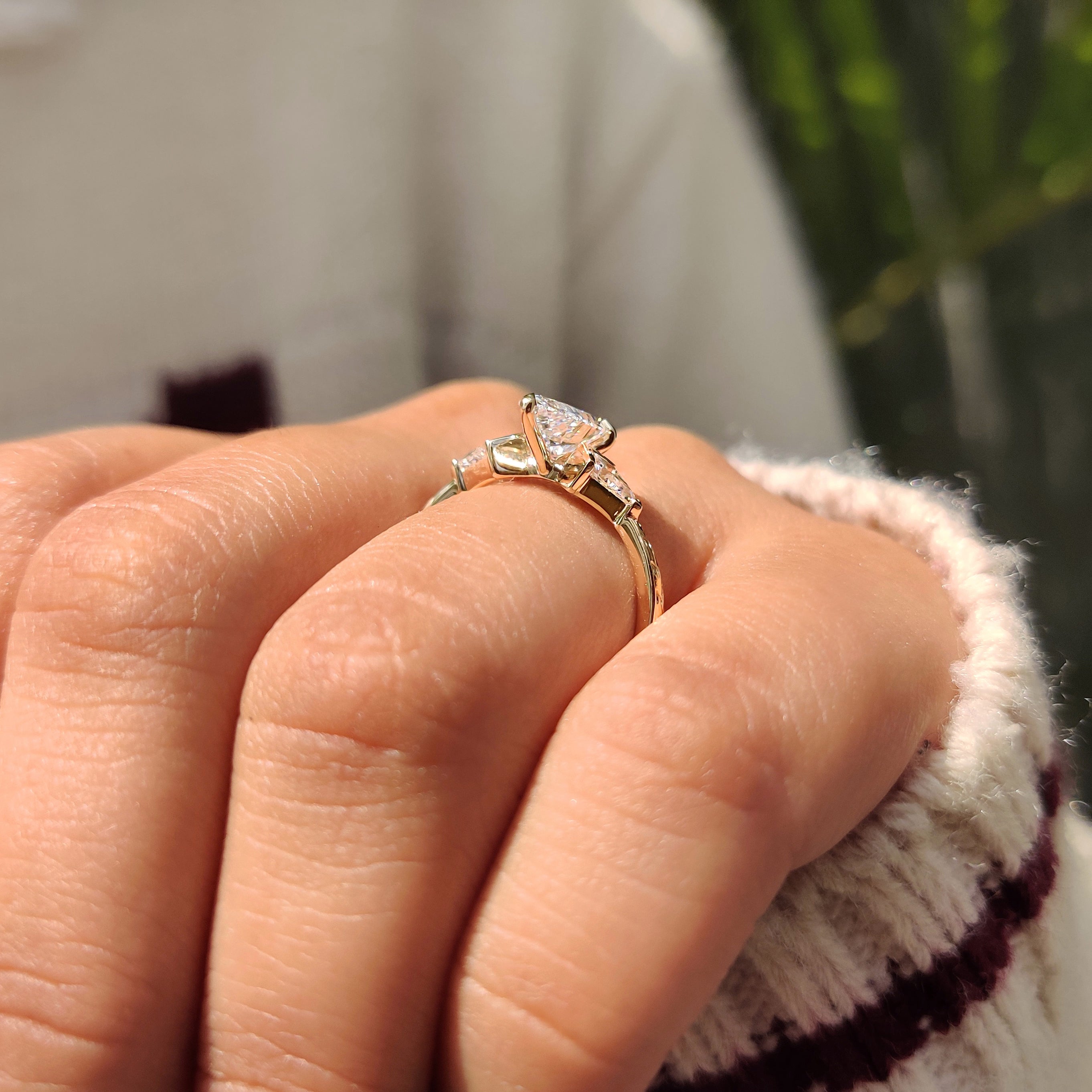 Lab grown pear diamond ring with kite side stones.
